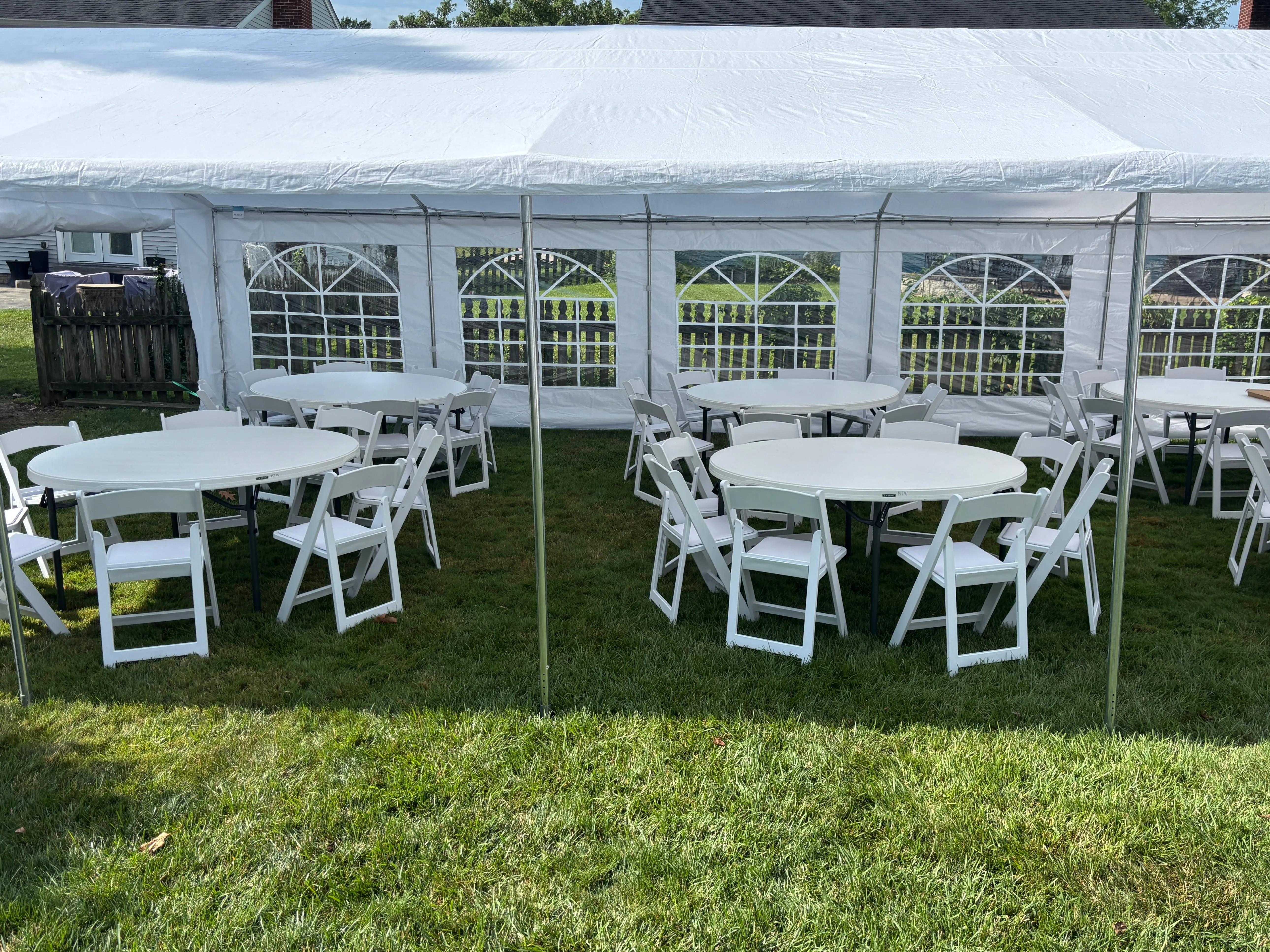 Graduation party rental setup with tables and chairs outdoors
