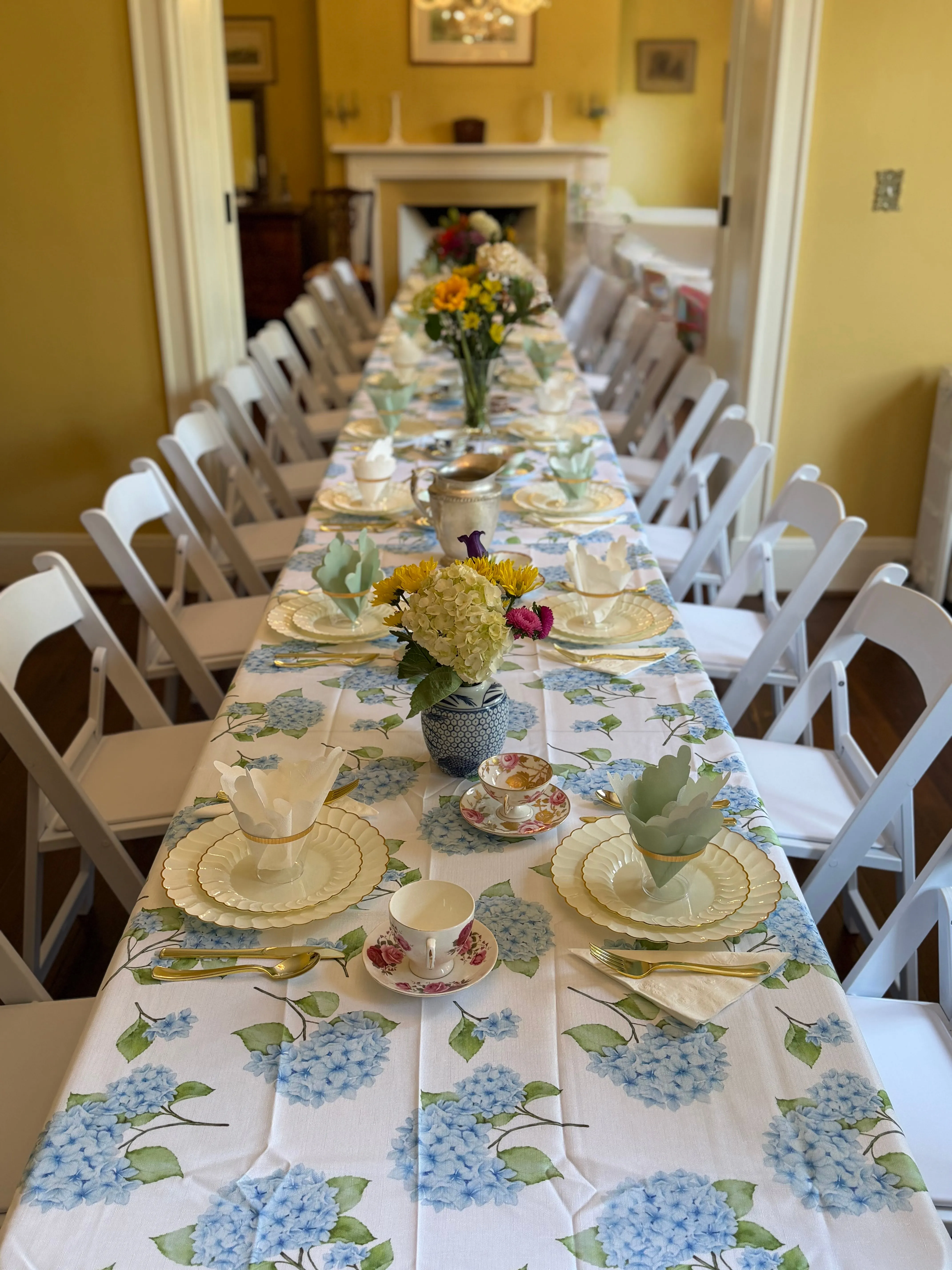 Baby shower table setting with white rental chairs and linens
