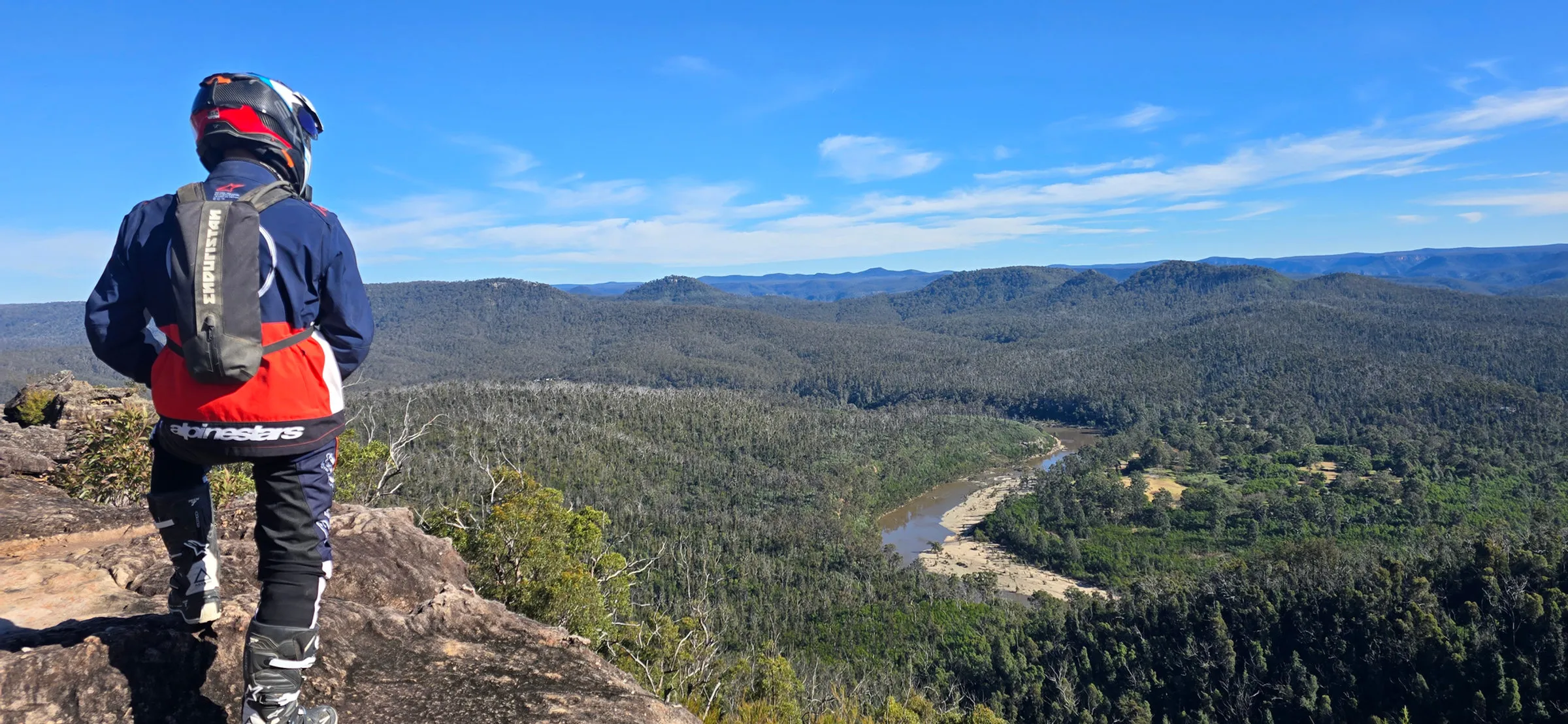 Adventure rider looking out over a river valley on a ride with Foxwood ADV