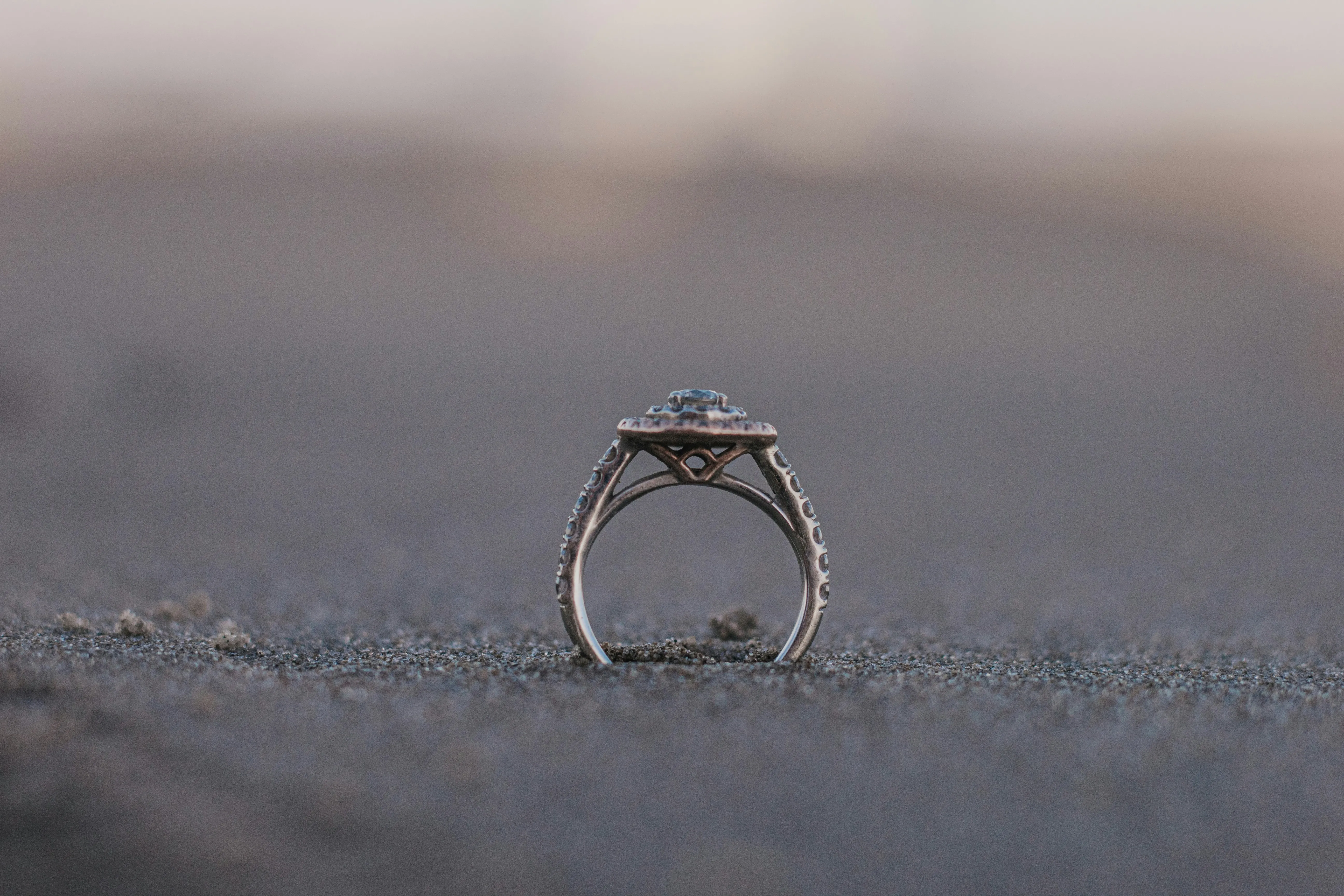 A wedding ring in the sand, symbolizing the everlasting bond of couples in the 207 area.