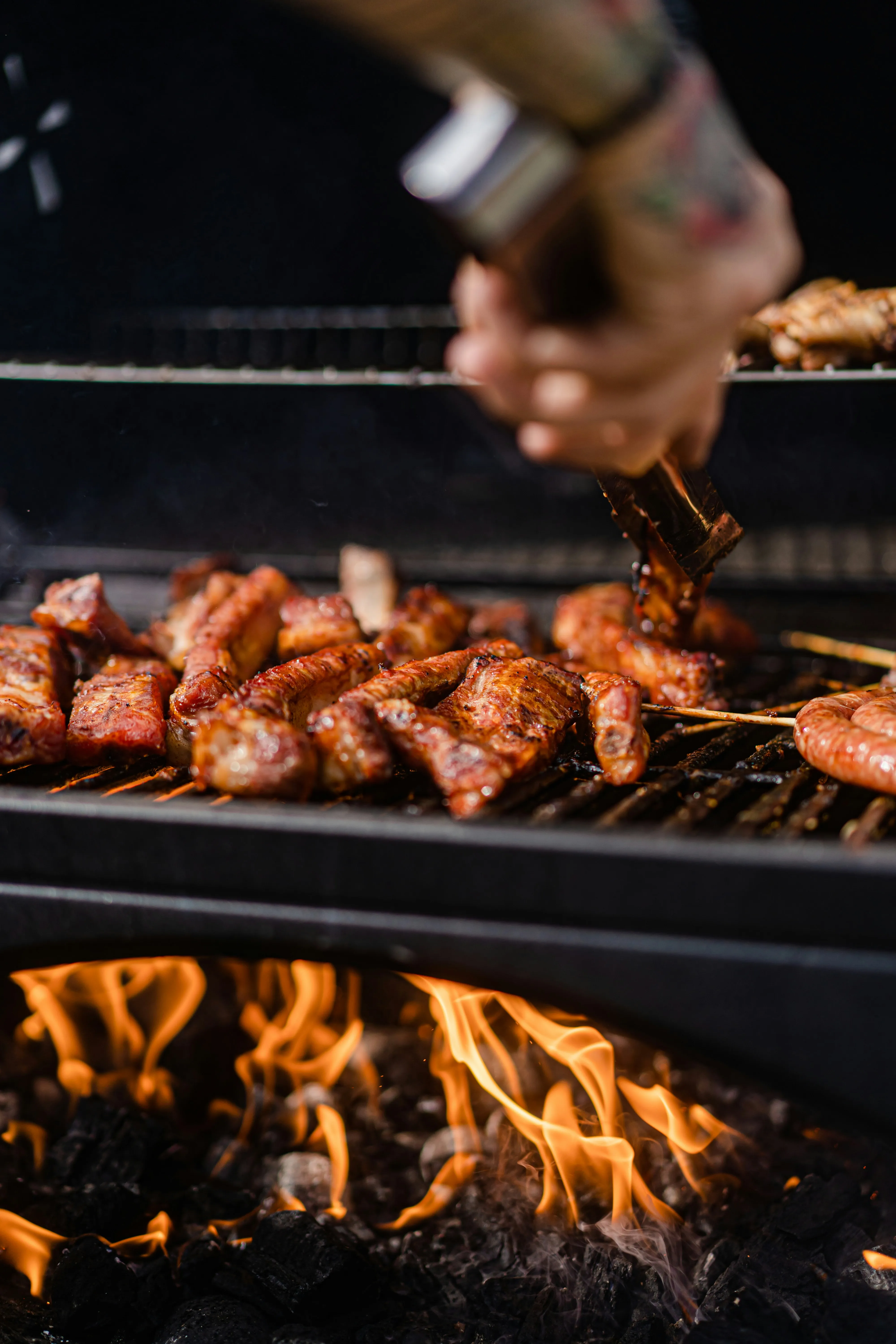 A man is grilling chicken, ready to rent tables for his family reunion.