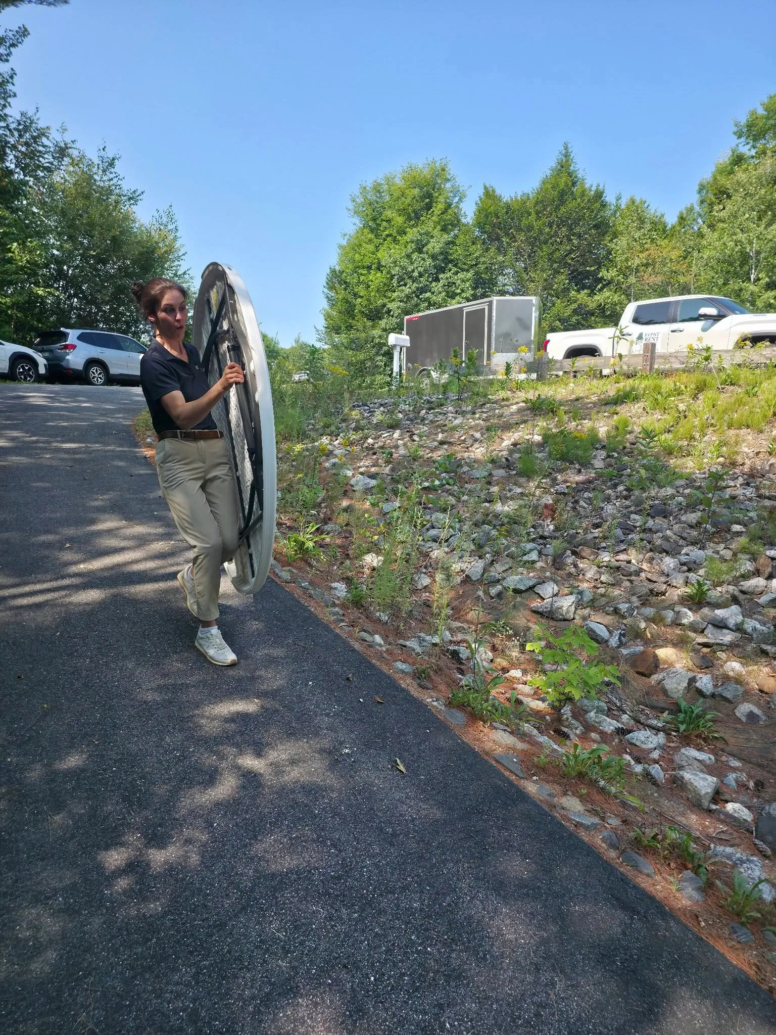 Becca carrying a table down a steep hill