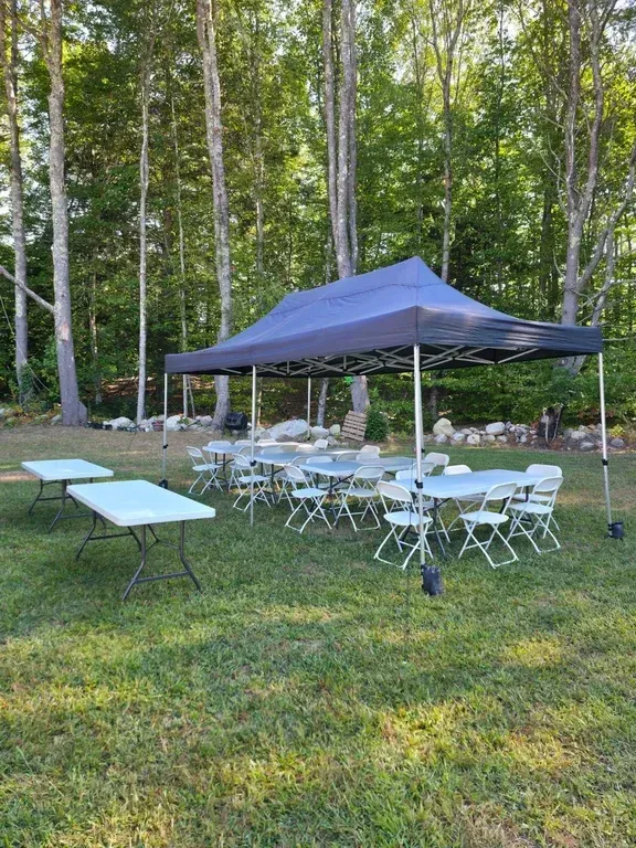 Bachelor party celebration with tent, tables, and chairs