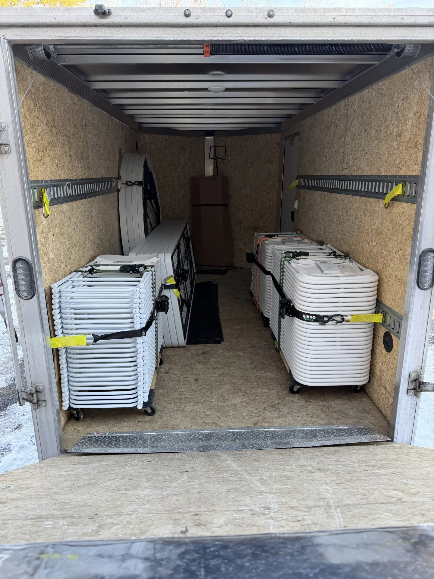 Tables and chairs in the back of a trailer