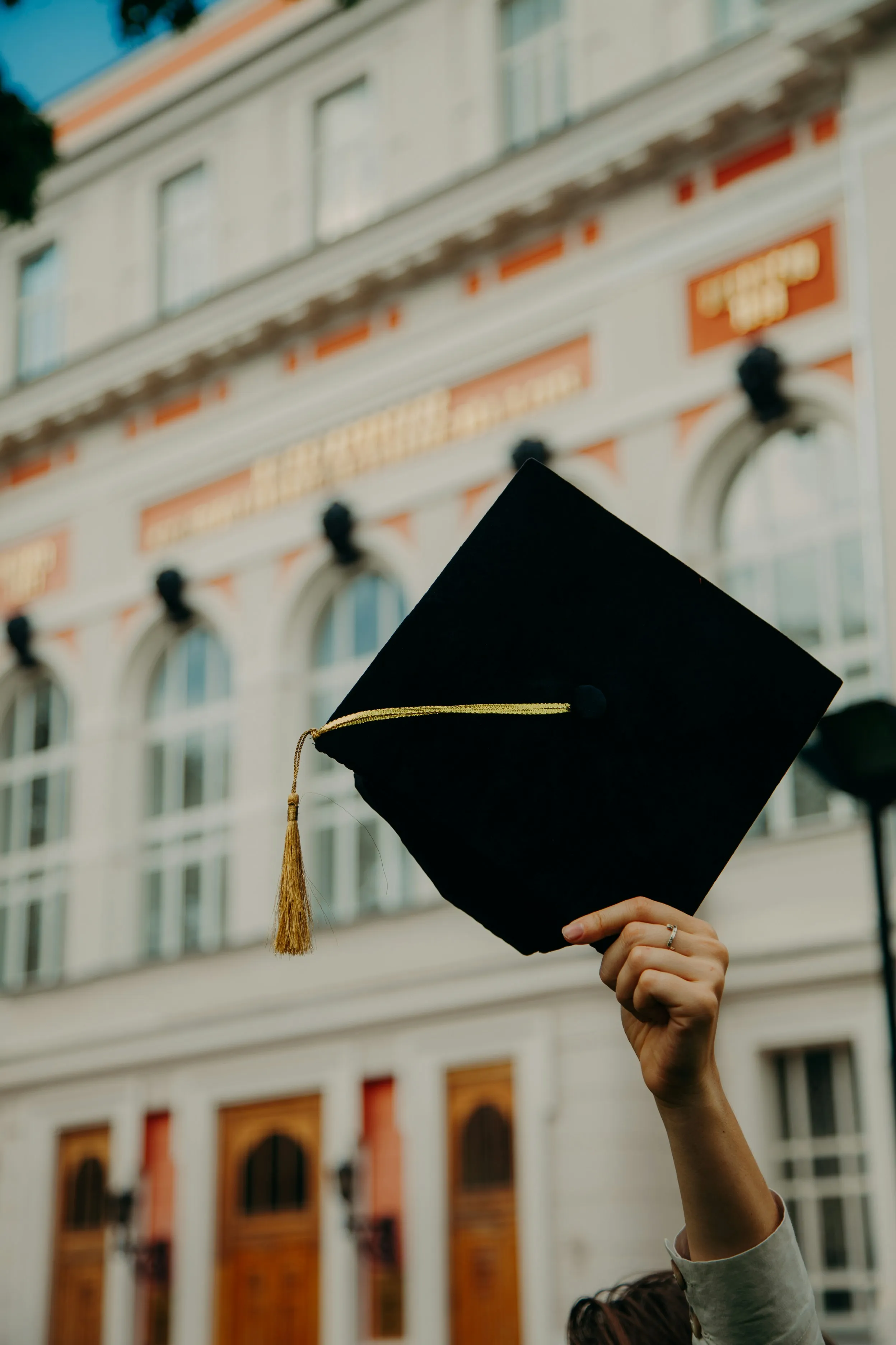 Graduation cap held in the air