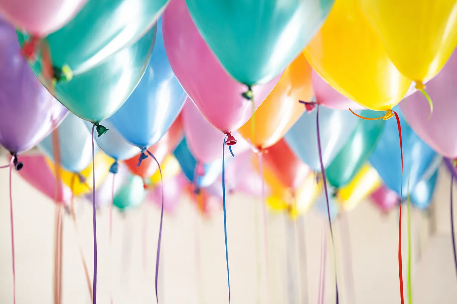 Colorful helium balloons floating overhead create a festive atmosphere for a birthday party, baby shower, or special celebration.