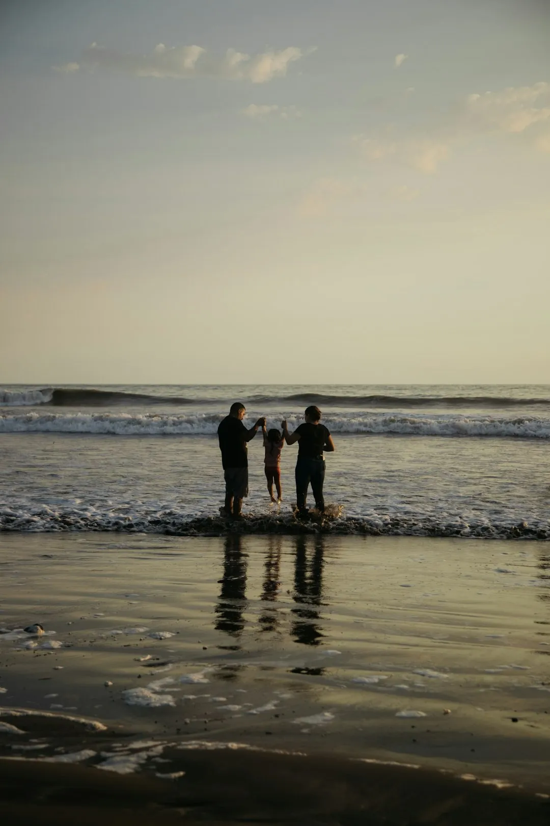 Wife and Husband on the Beach with Small Child