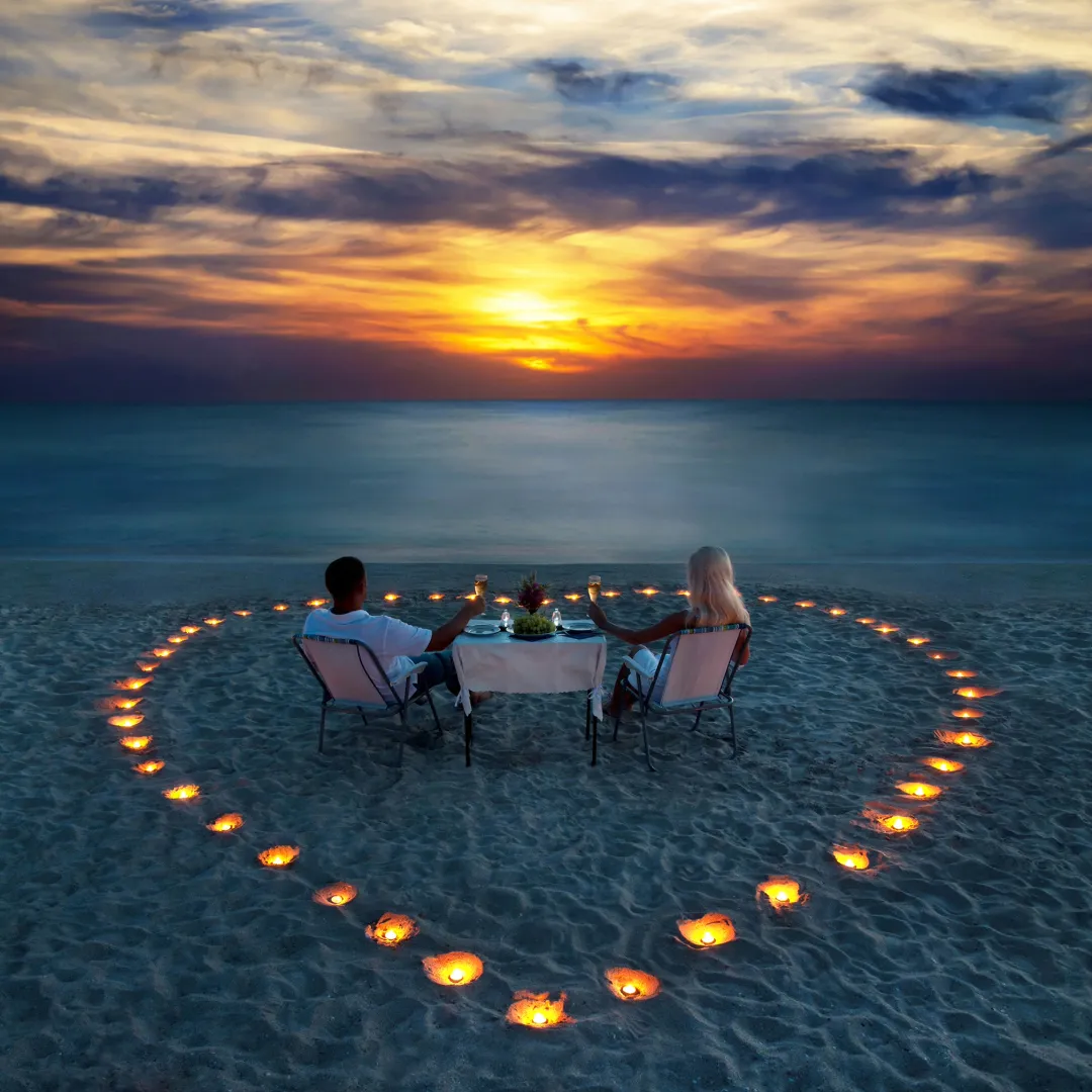 Romantic dinner on beach with couple. Beach view with candles.