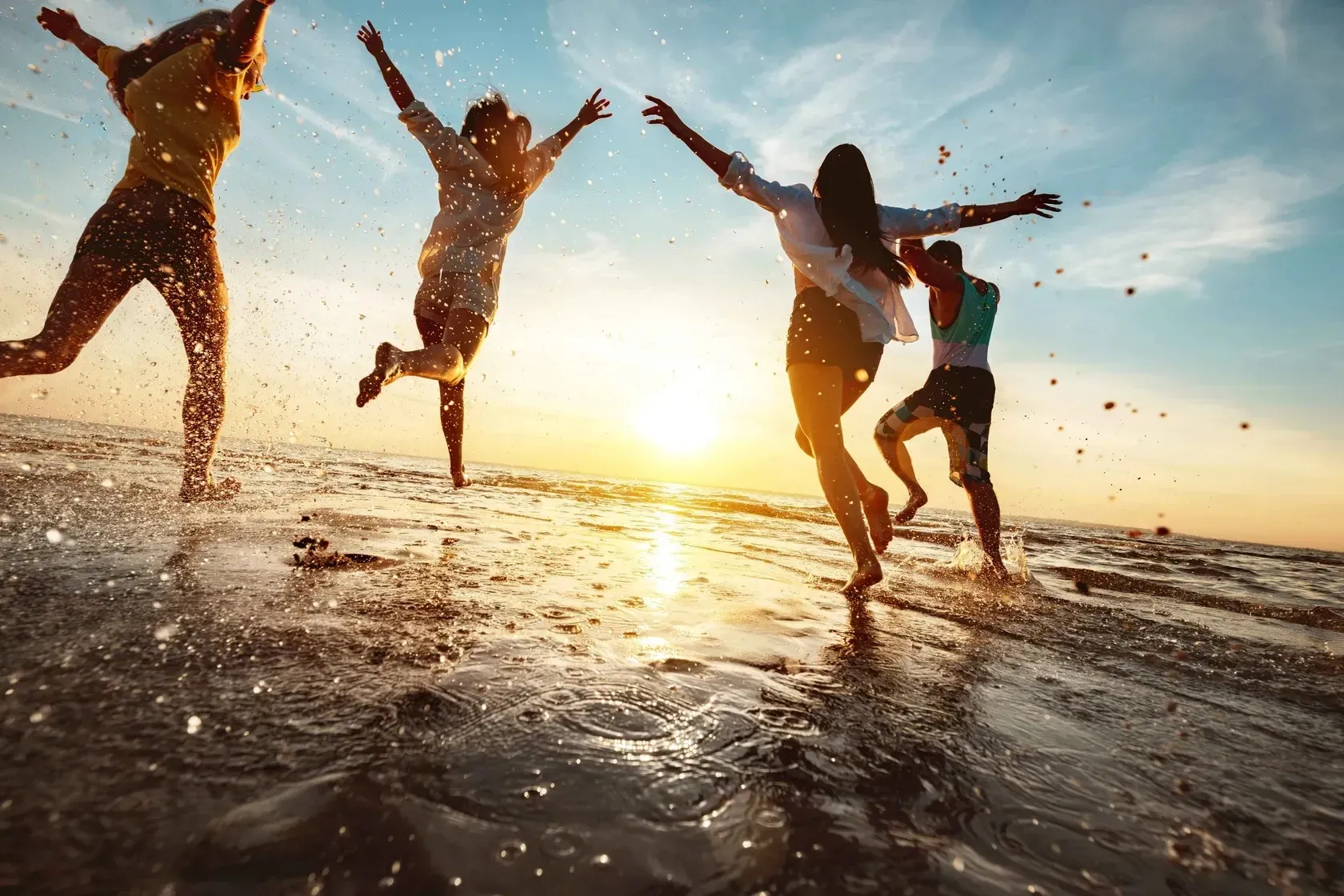Family running through Water at beach