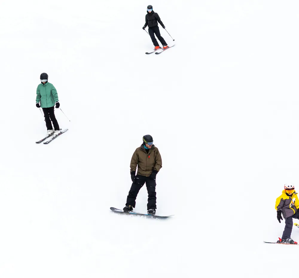 Family skiing down a mountain in Whistler BC, Canada