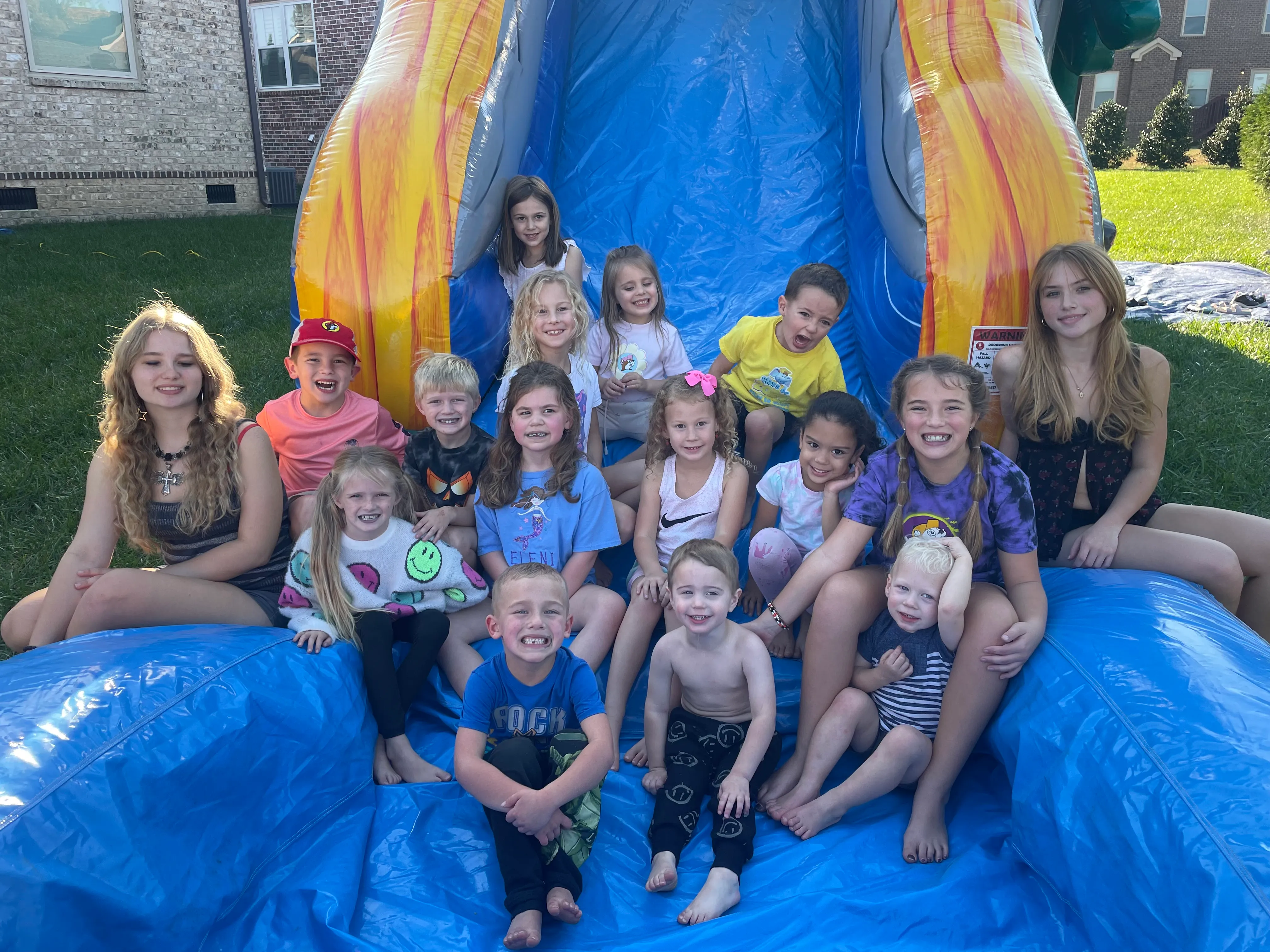 Children enjoying a water slide rental from Spring Hill Inflatables, providing bounce house and water slide rentals in Spring Hill, Thompson's Station, Columbia, Franklin, and surrounding Middle Tennessee communities.
