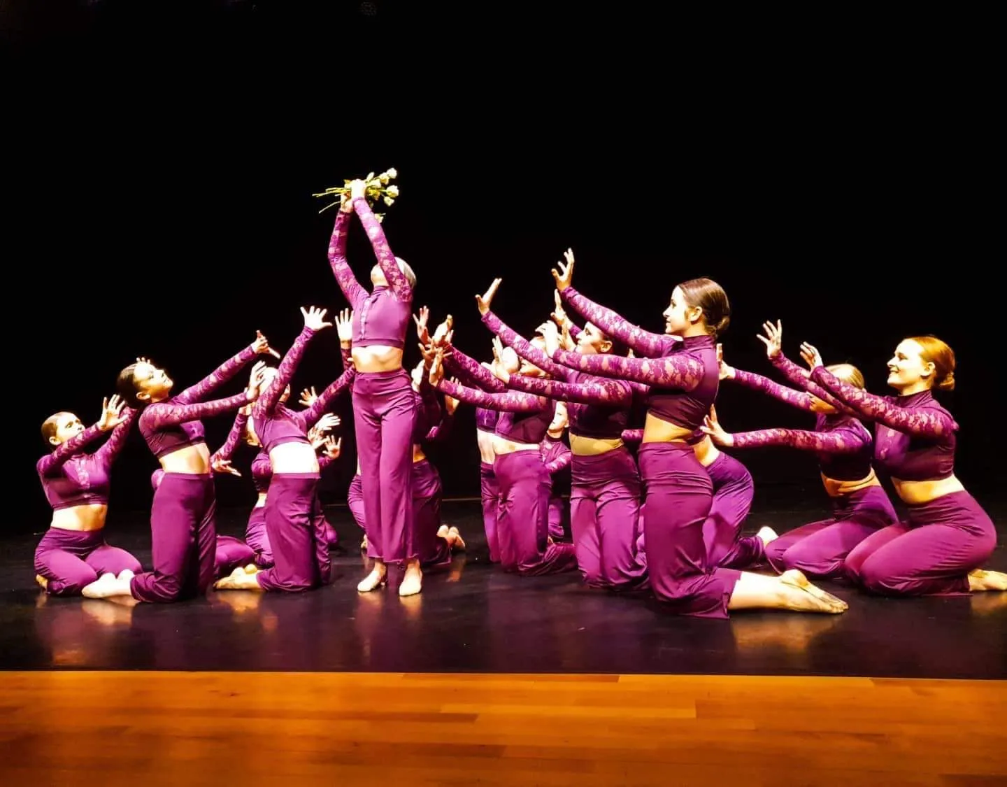 Dancers in pink costume performing on stage