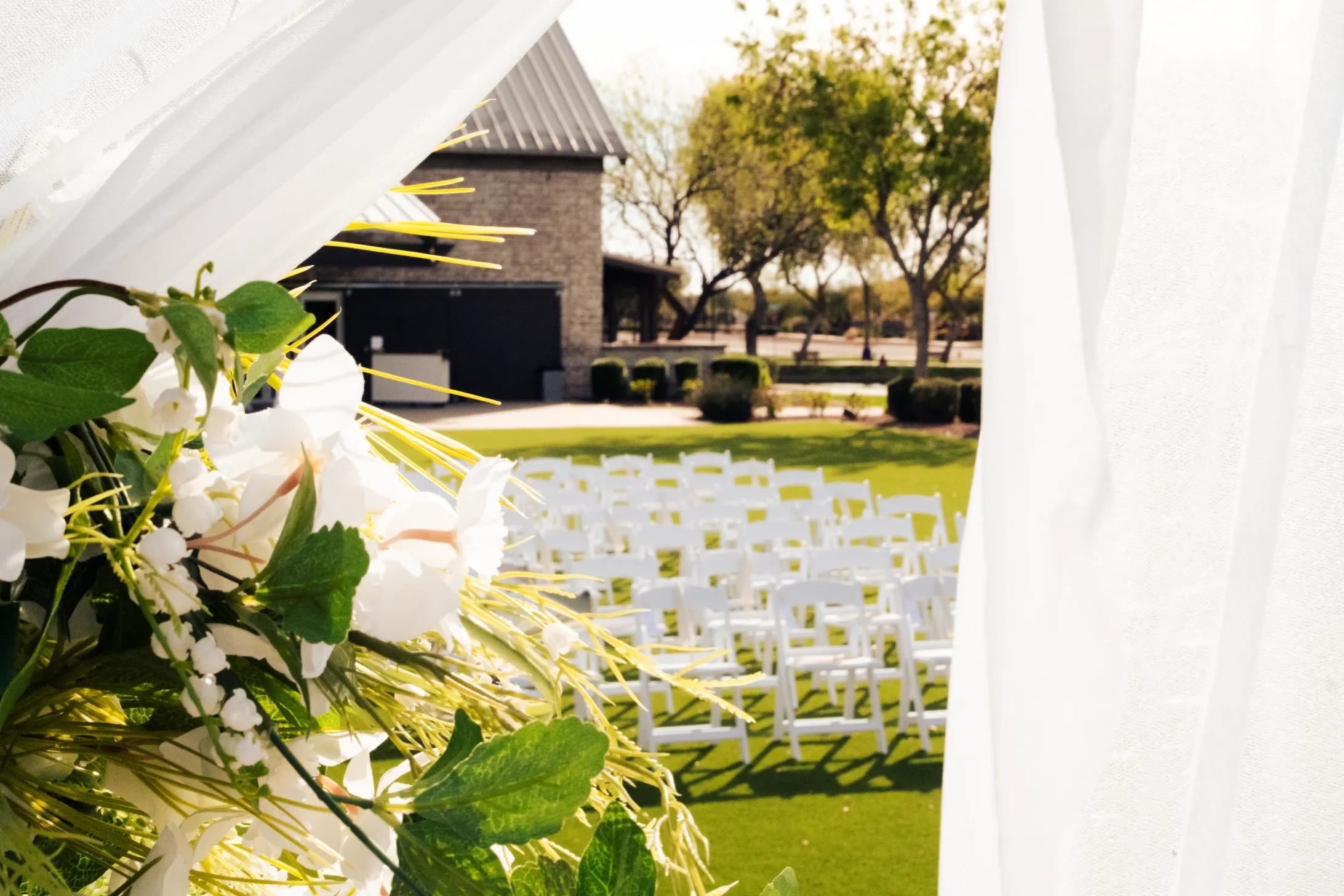 A wedding ceremony with groom, bride, officiants, and wedding party.