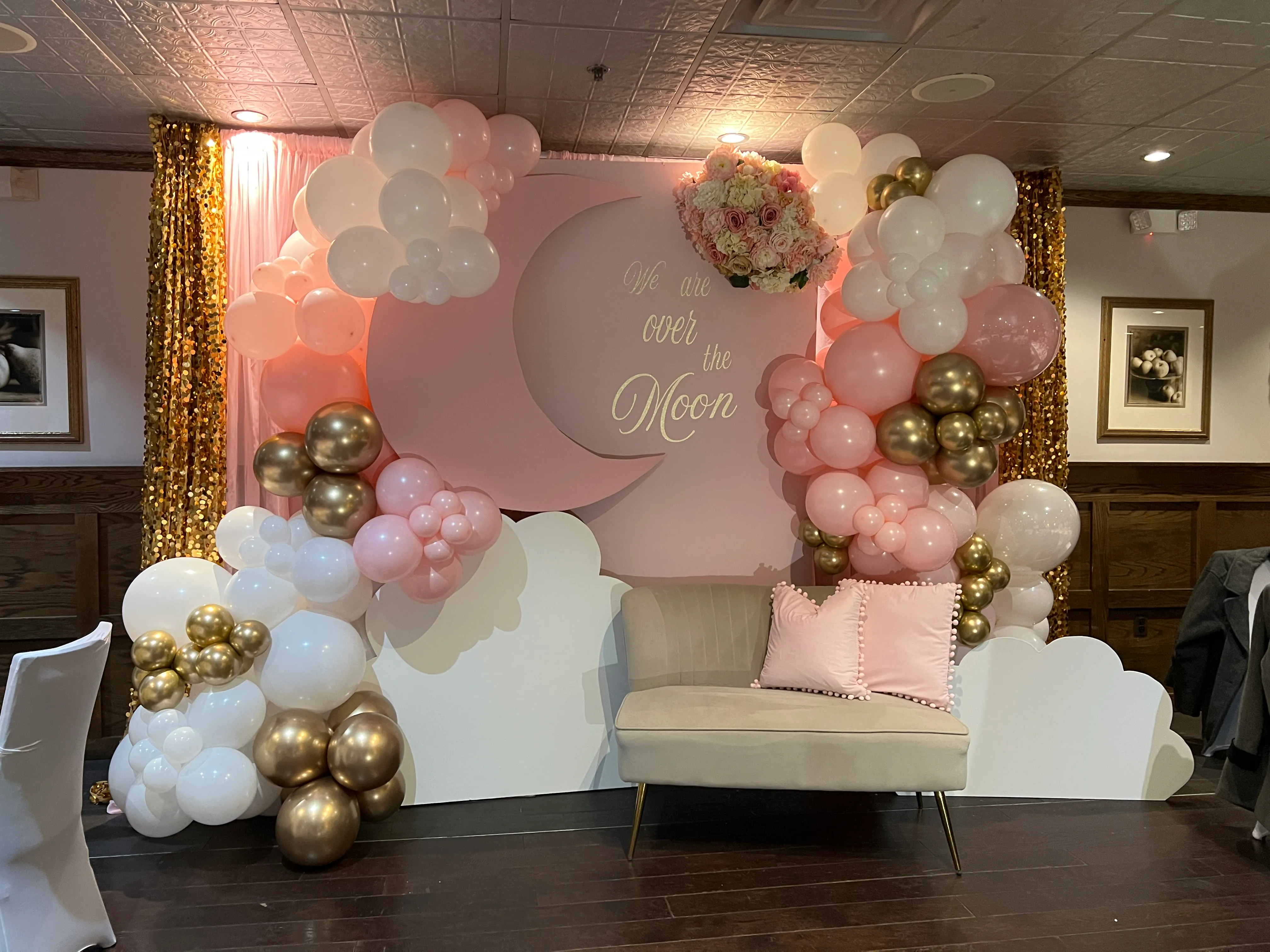 Blush pink DIY backdrop rental with luxe balloon garland and lounge seating for baby shower or bridal event in New Jersey.