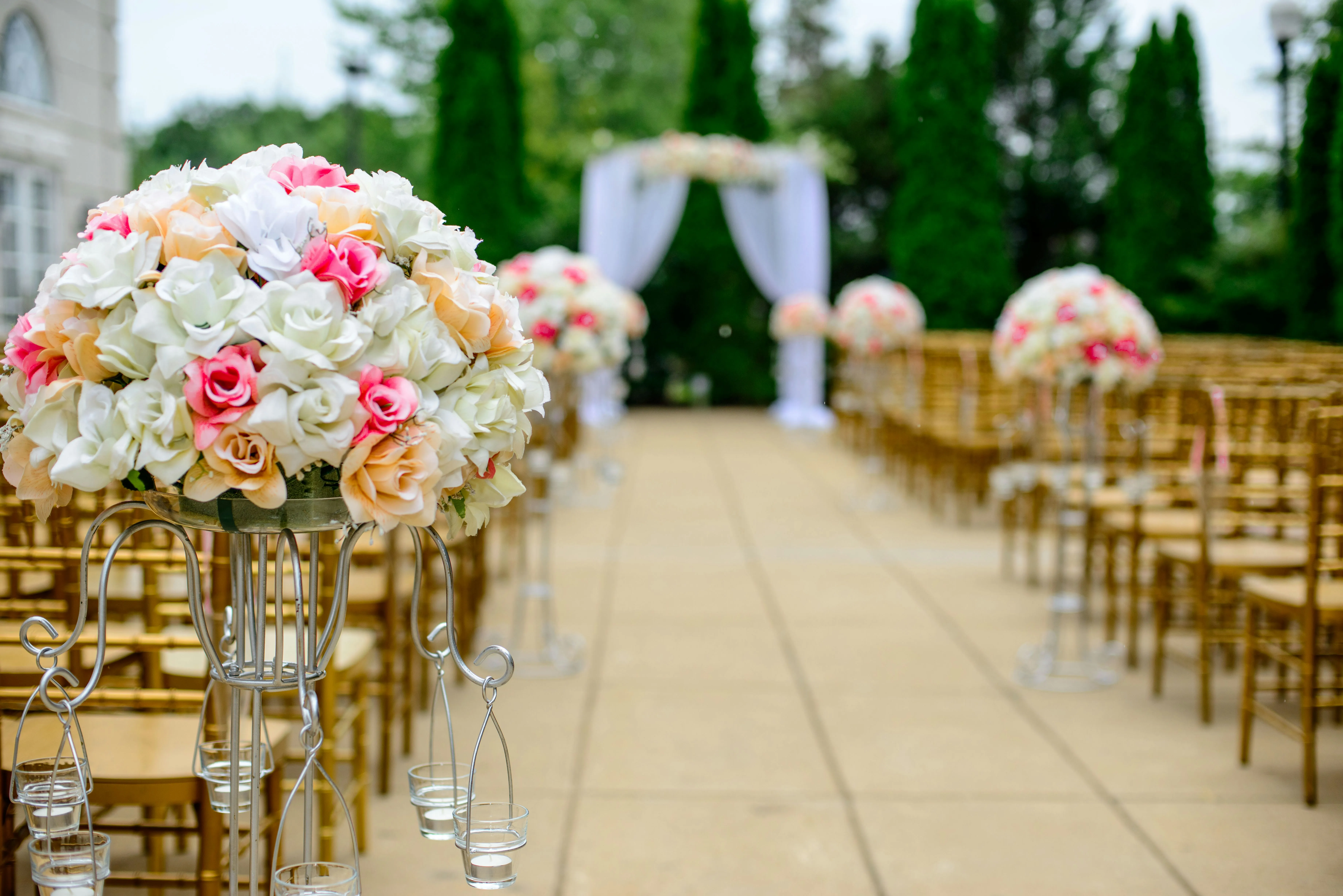 Wedding arbor at the end of the aisle with bouquet aisle markers