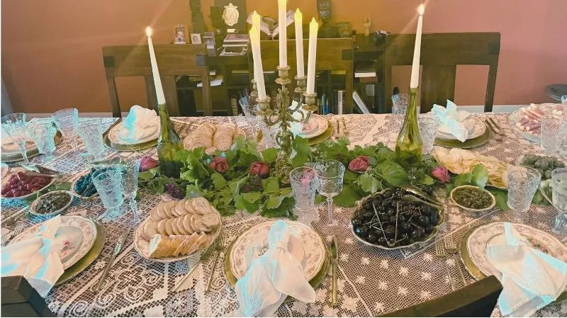 Vintage table setting with lace, crystal glass and limoges plates with a how to order button.