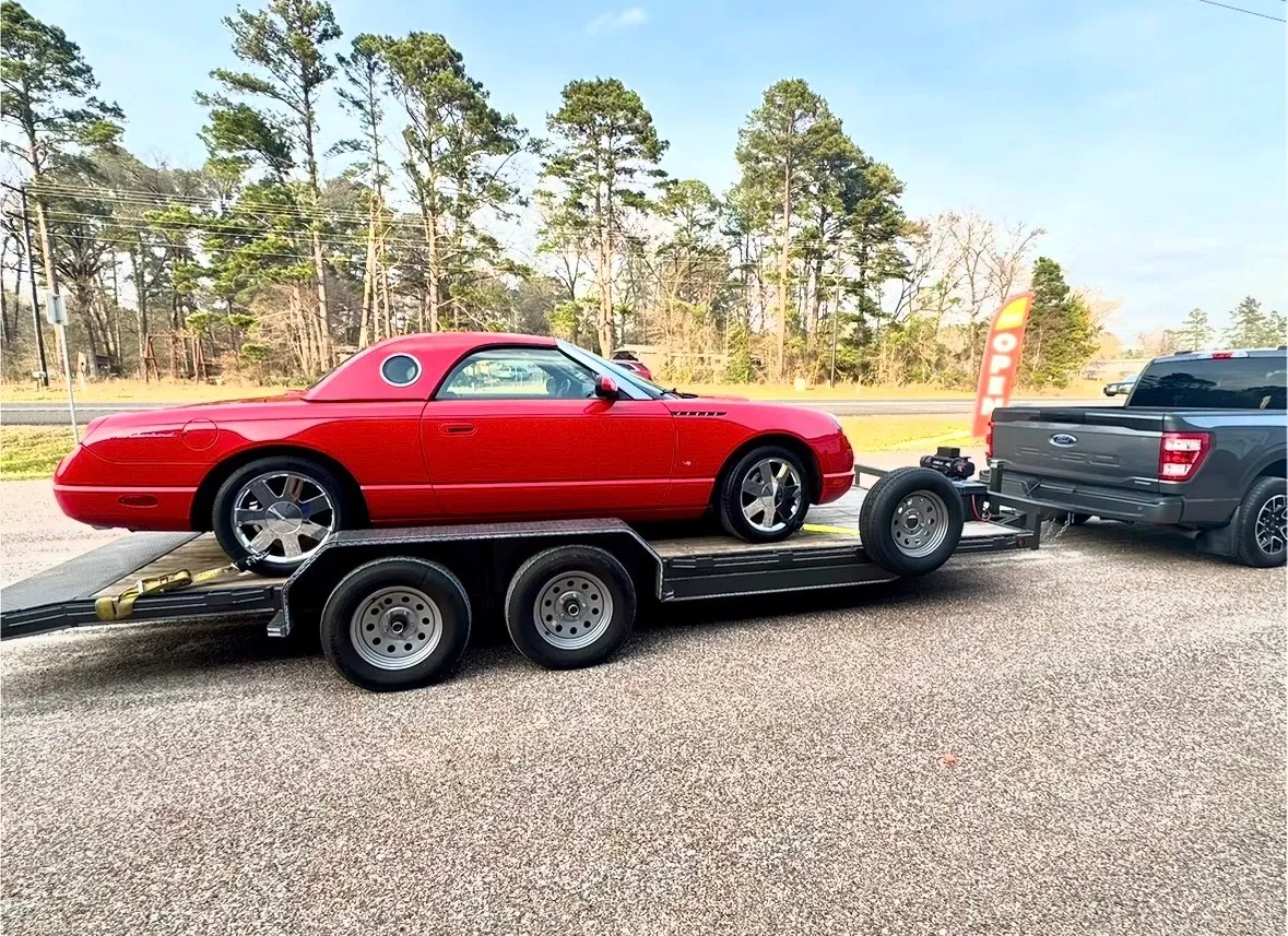 Red Car loaded on car hauler