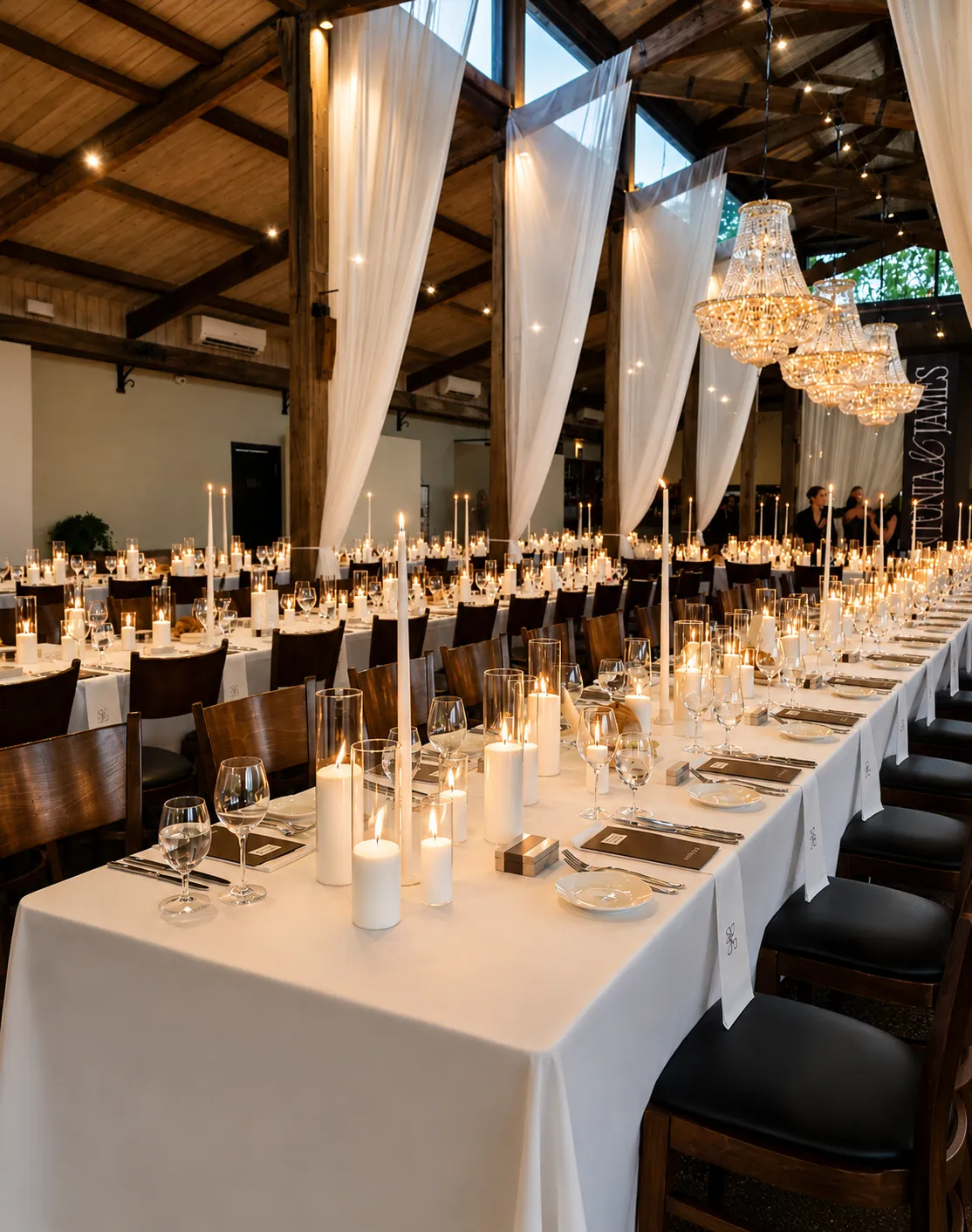 Stones of the Yarra Valley wedding reception featuring abundant candle styling, timber architecture and sweeping ivory drapery