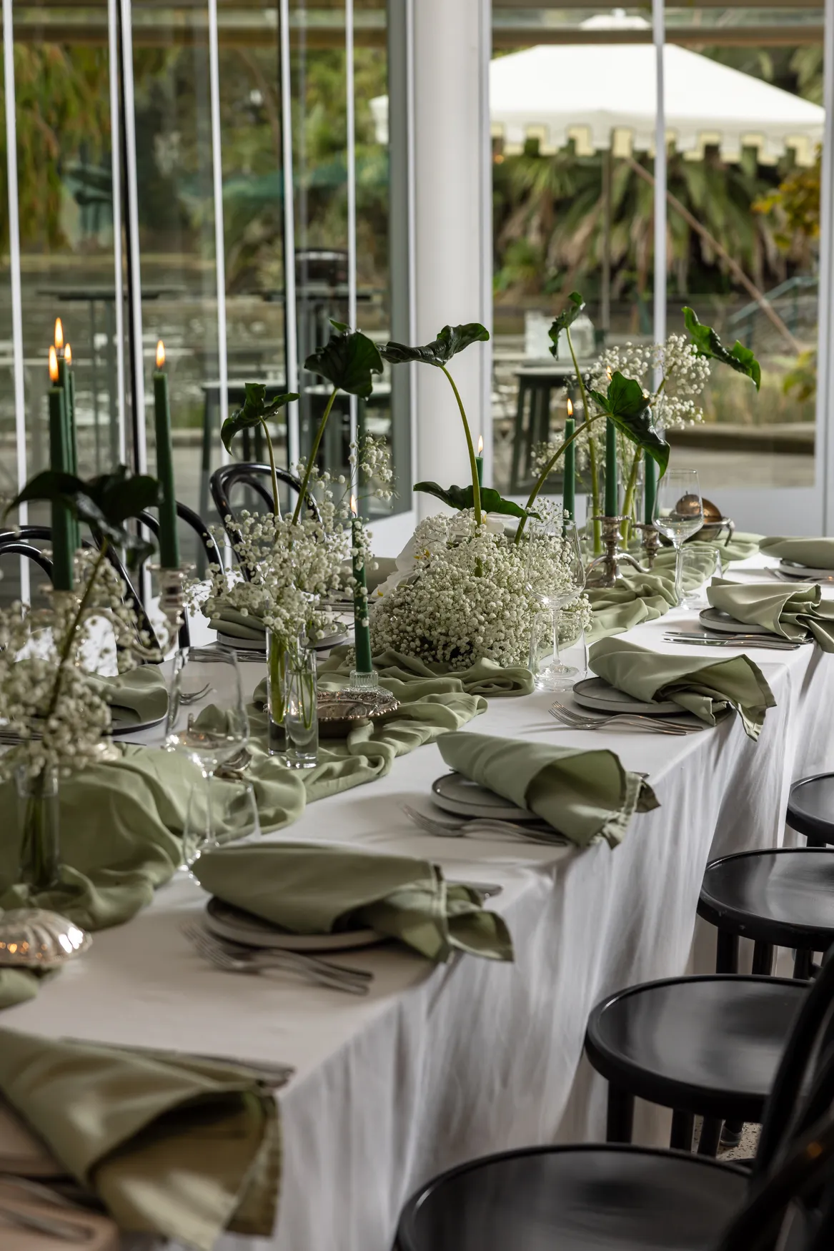 Ivory, sage and green tablescape styling at The Terrace, featuring layered linens, elegant florals and refined event décor.