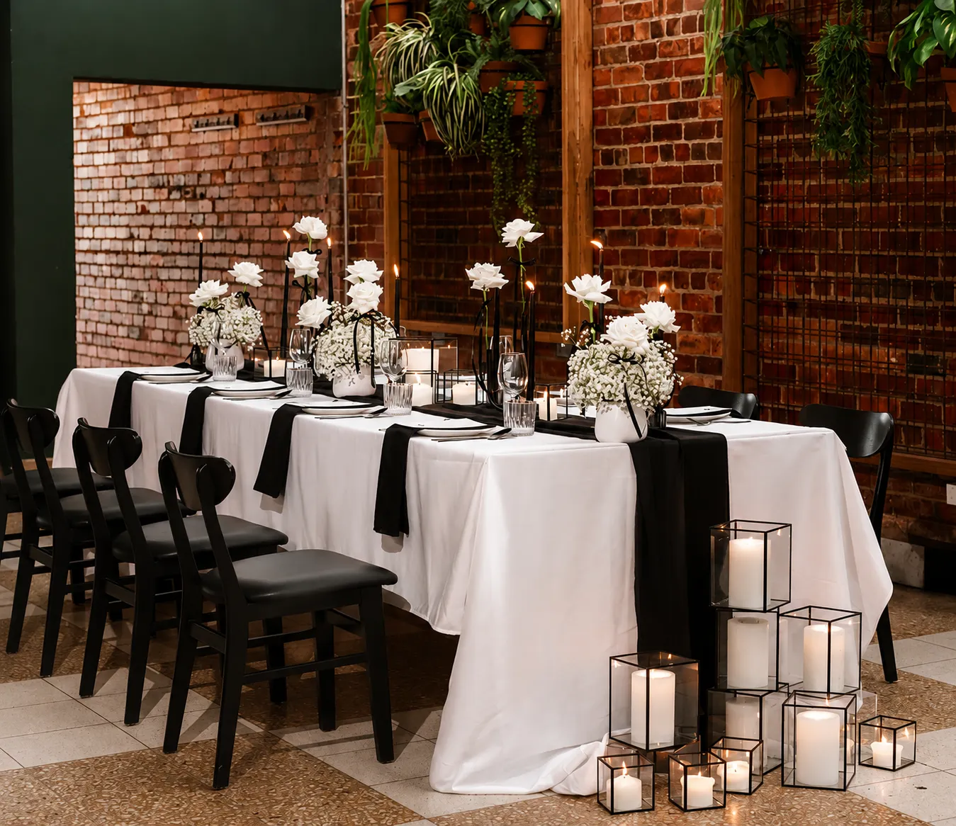 Black and white tablescape with white roses, black accents and layered candle styling in a Melbourne event space by Miss Events Melbourne @thepostofficehotel