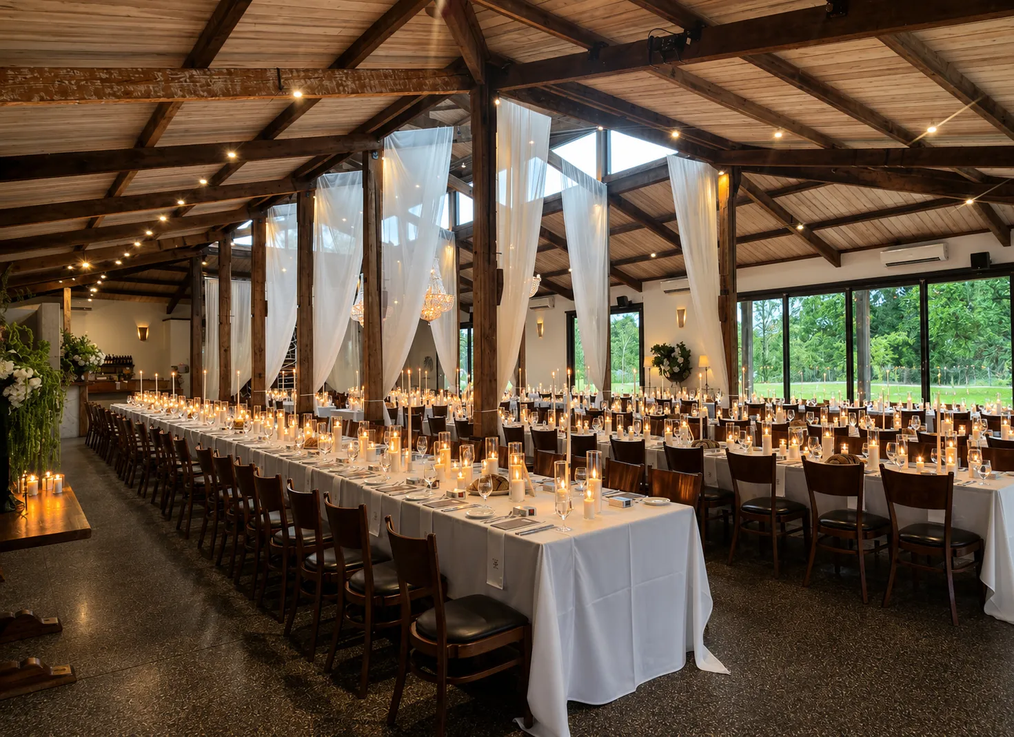 Long wedding banquet tables illuminated with layered candles beneath ivory drapery at Stones of the Yarra Valley