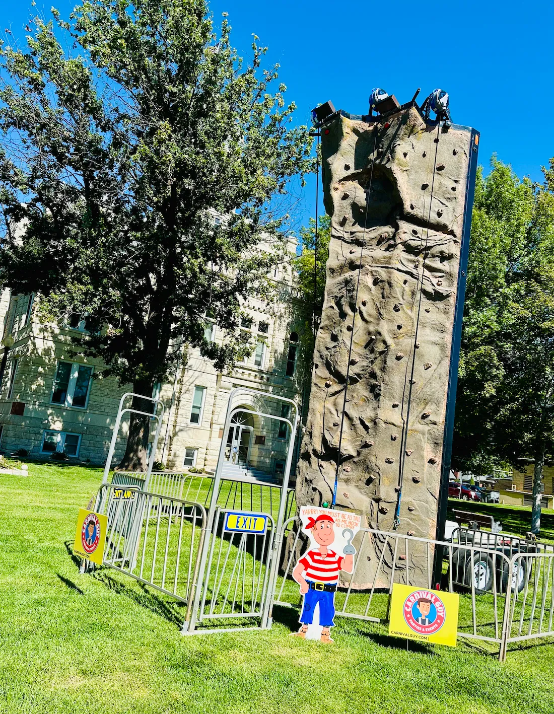 Our rock wall rental providing a fun and challenging team-building activity for corporate employees, promoting teamwork and communication as they work together to conquer the wall.