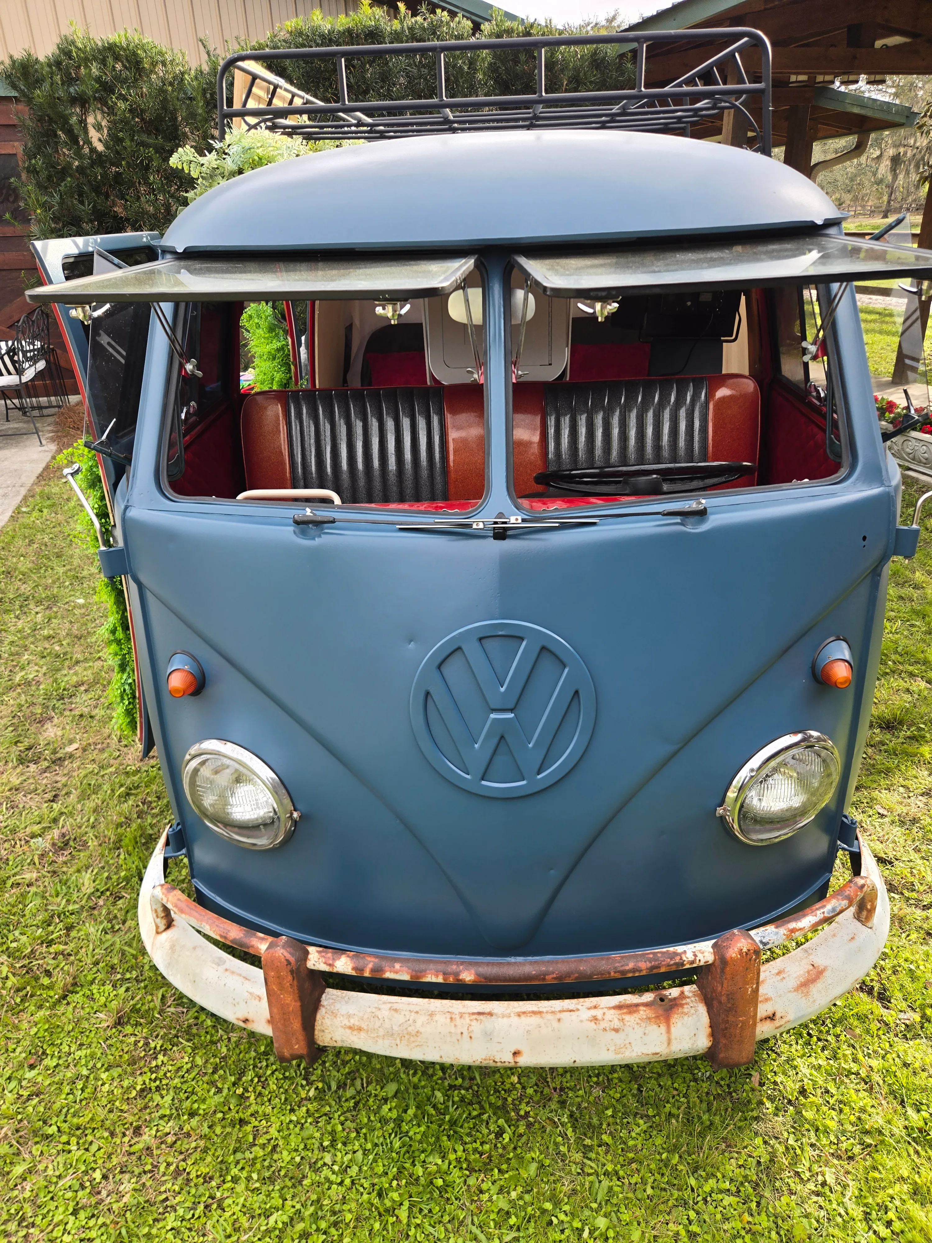 A blue vintage Volkwagen split-window bus, converted to a photo booth