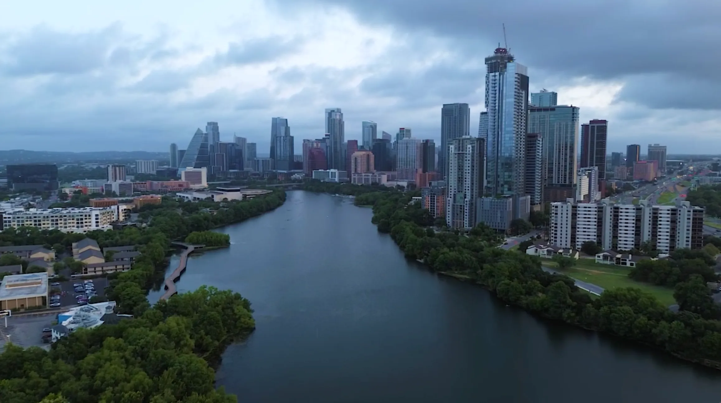 Exploring the iconic Shoal Creek trail on e-bikes with Austin skyline in background.