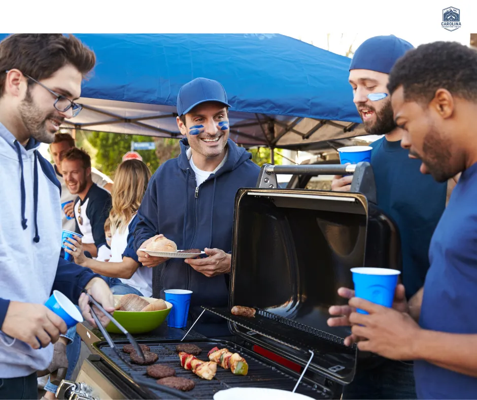 Guys grilling out while they tailgate