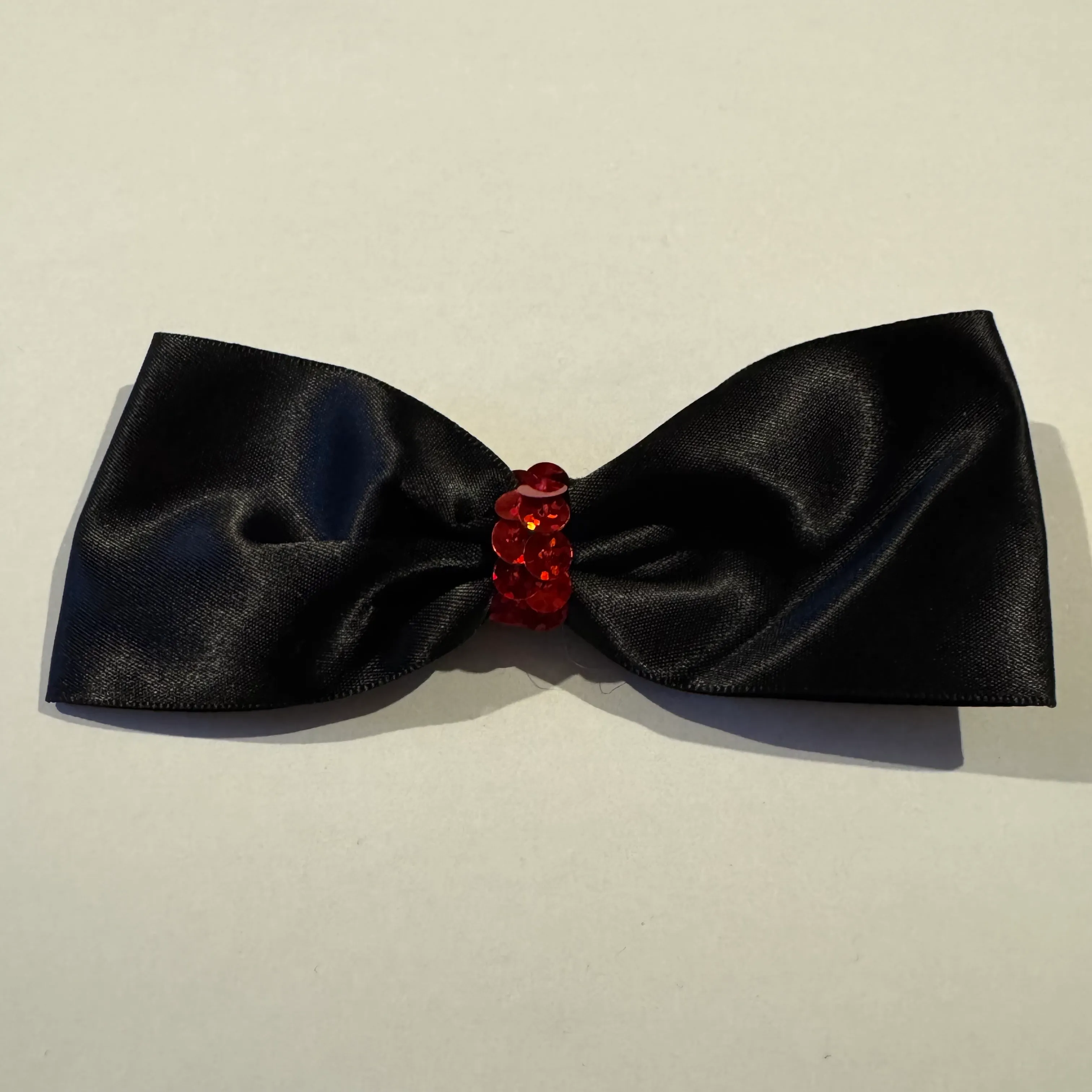 BLACK HAIR BOW WITH RED SEQUIN CENTRE