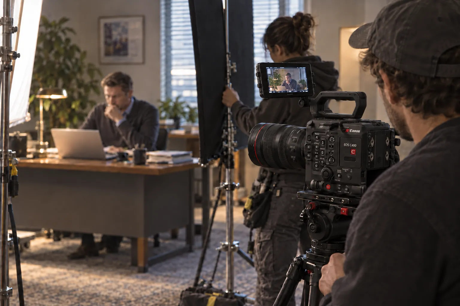 Camera operator and lighting crew preparing an interior shot in a confined room