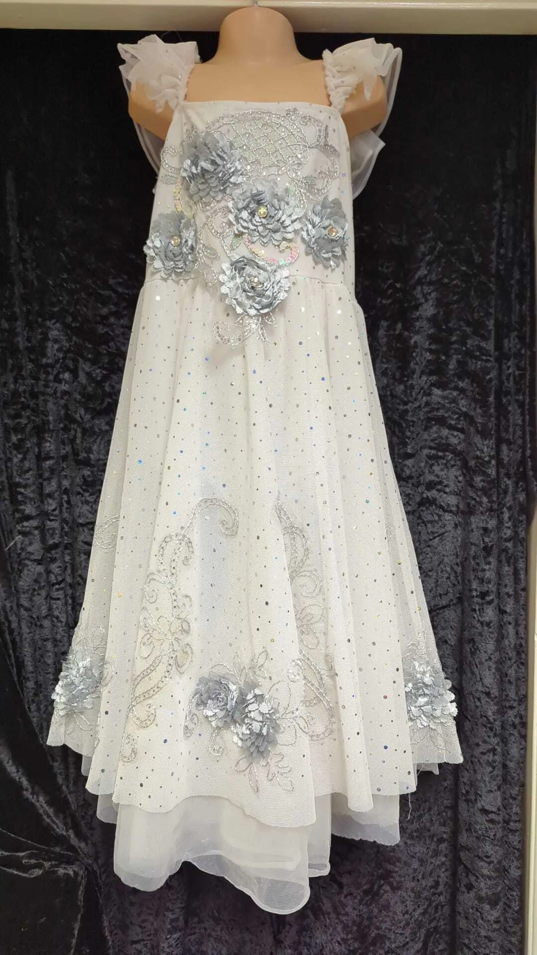 White lyrical dress with net over and additional detail in sequins and silver flower detail