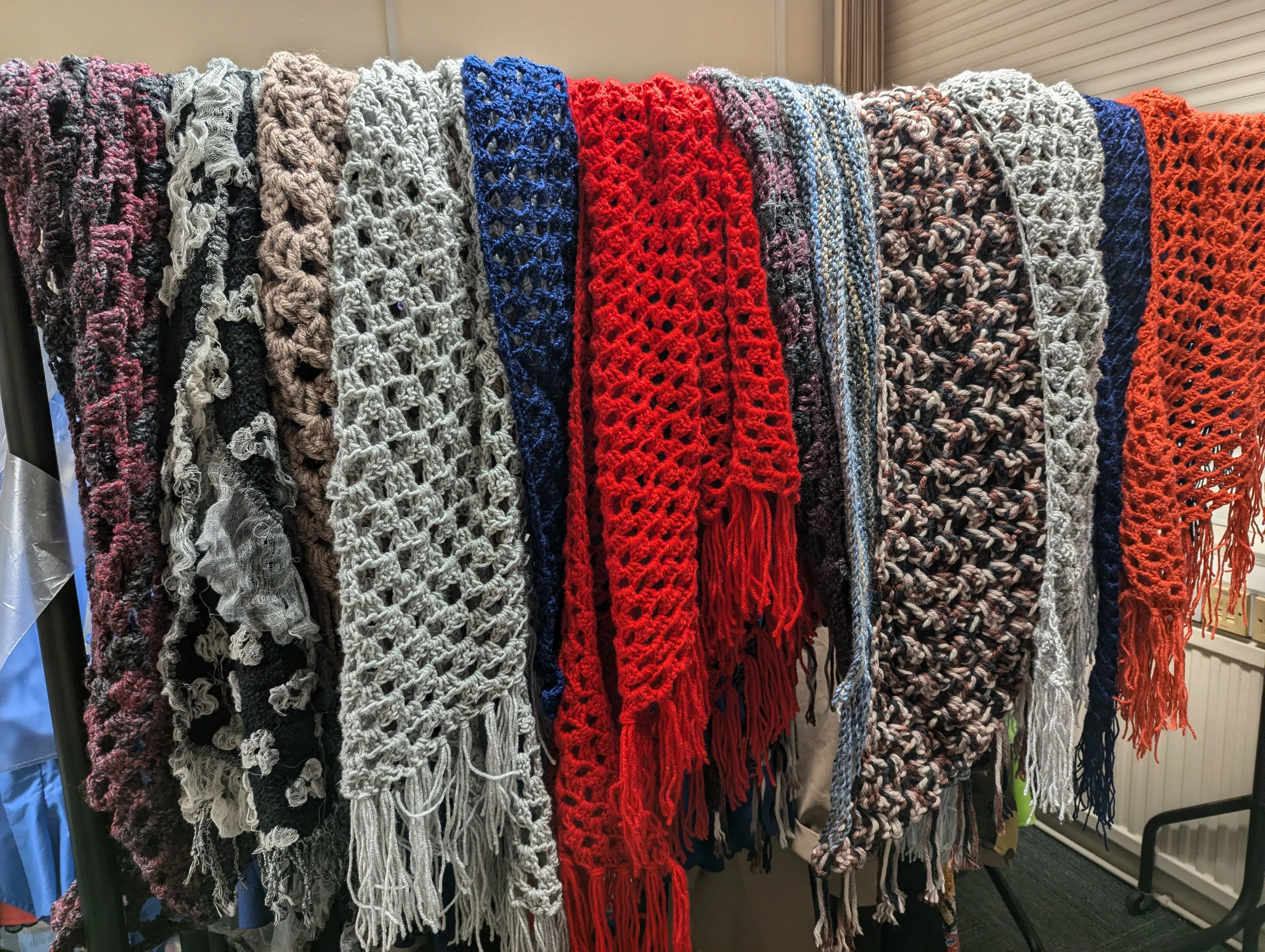 Selection of multicoloured wollen shawls.