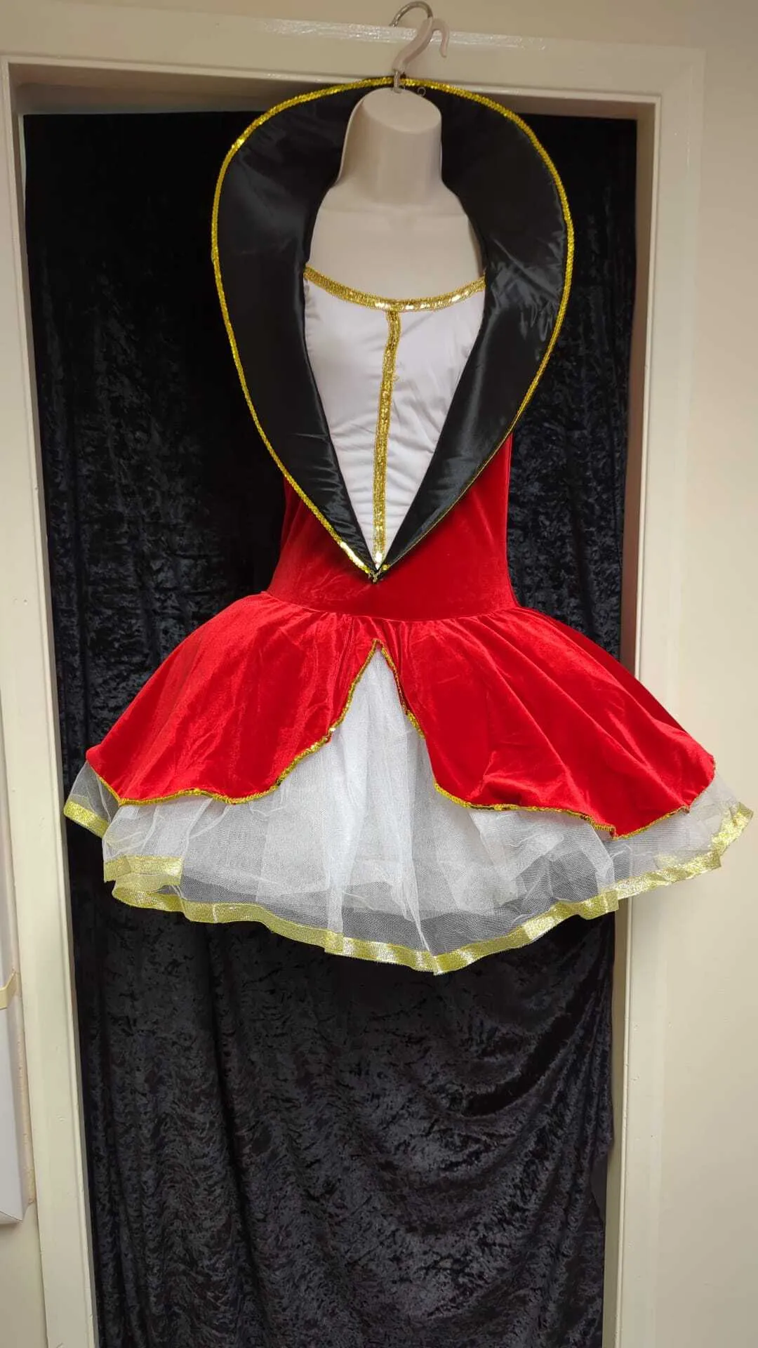 Red tut style costume with gold detail and black neck