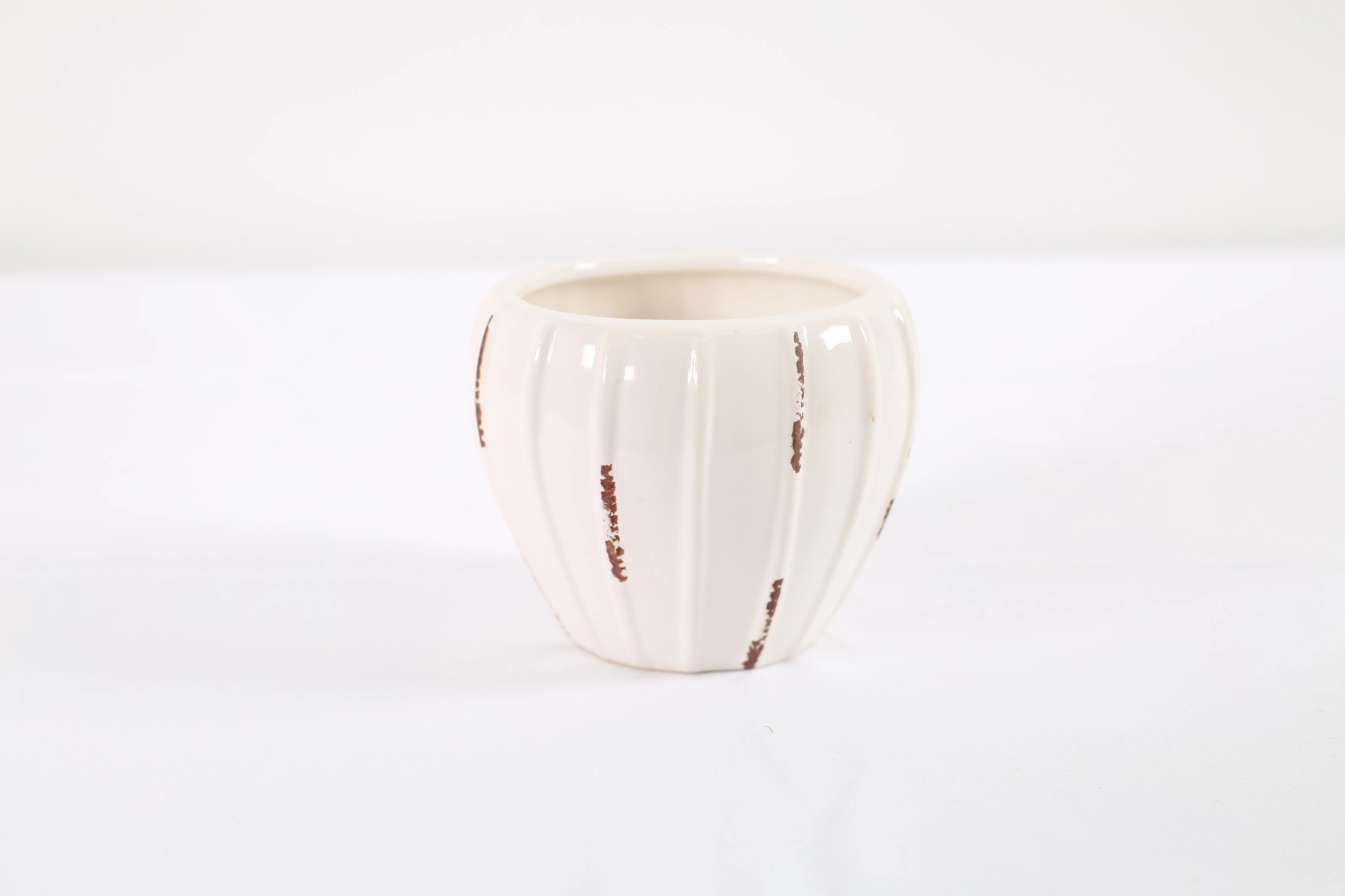 Beige pottery vase with red details