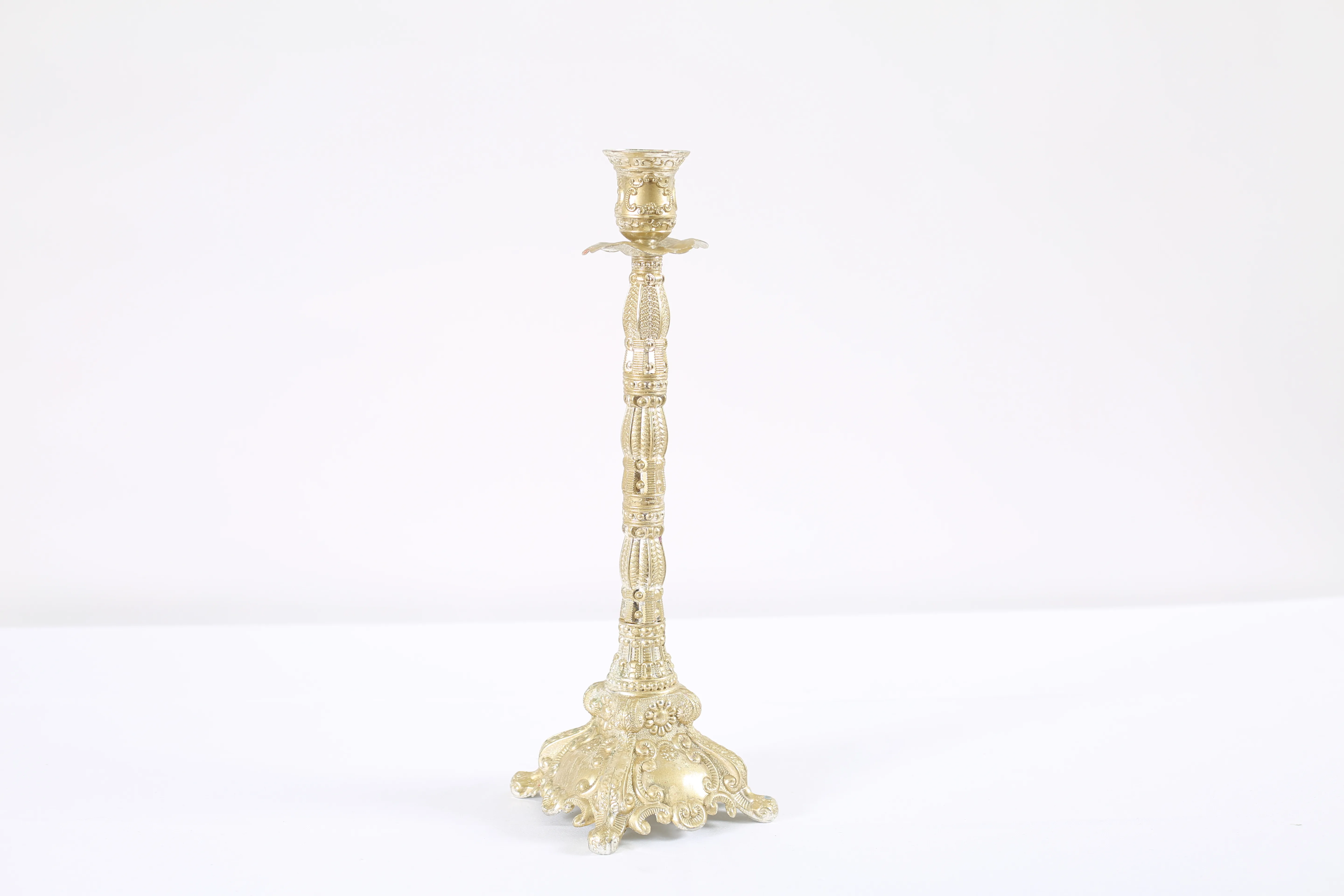 Gilded candlestick with pattern