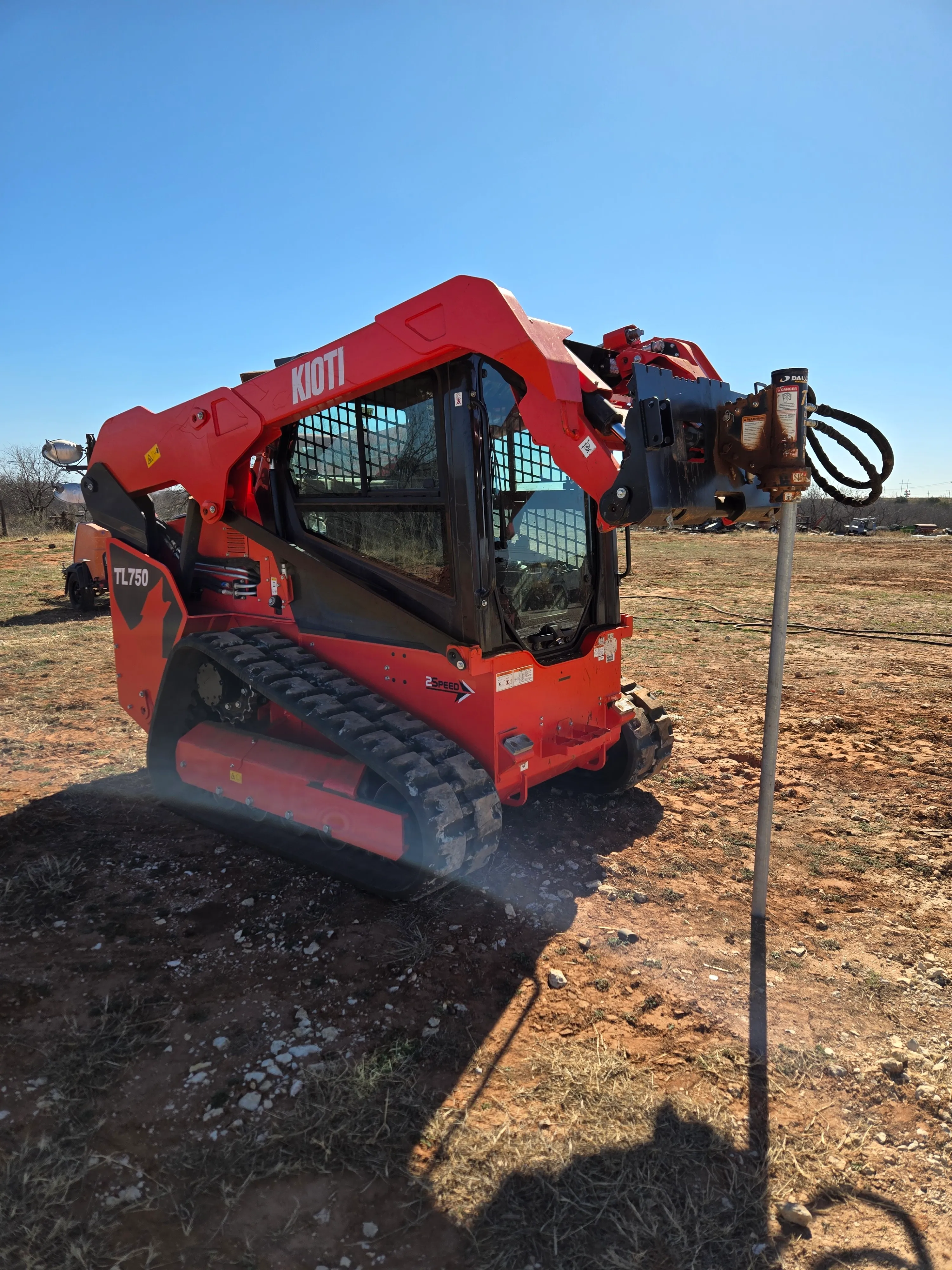 Kioti 75 HP skid steer/bobcat with post driver