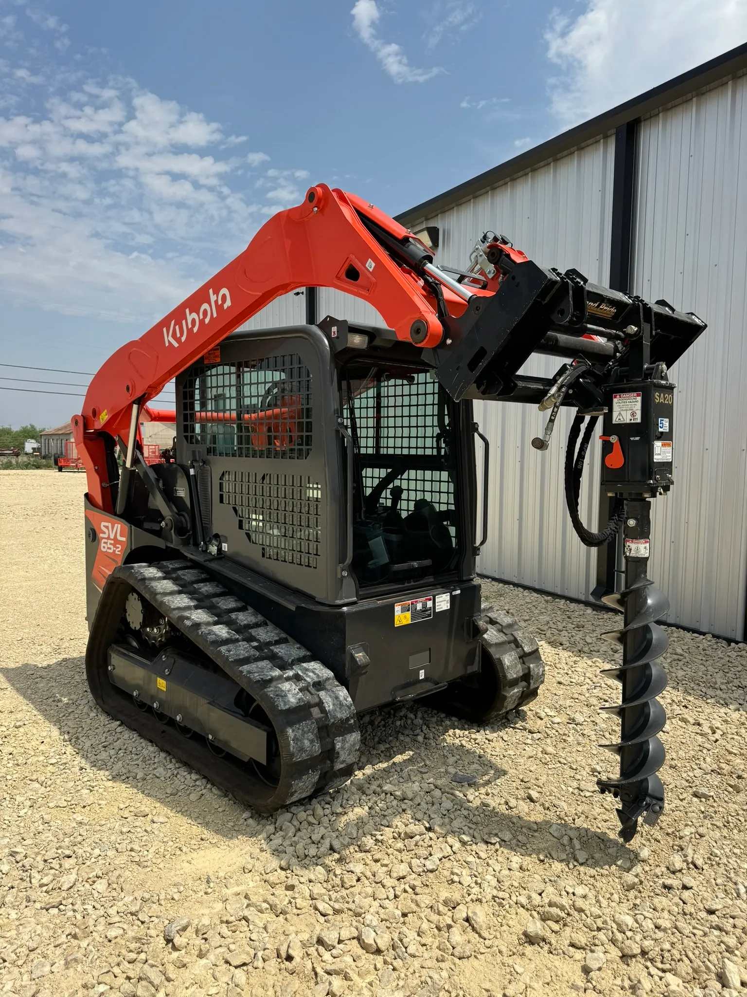 Kubota 65 HP skid steer/bobcat with hydraulic auger attachment and bit