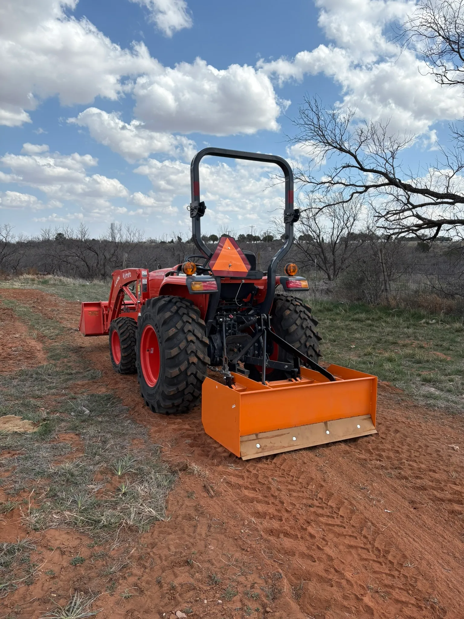 Tractor with 3-point box blade with rippers (48 in)