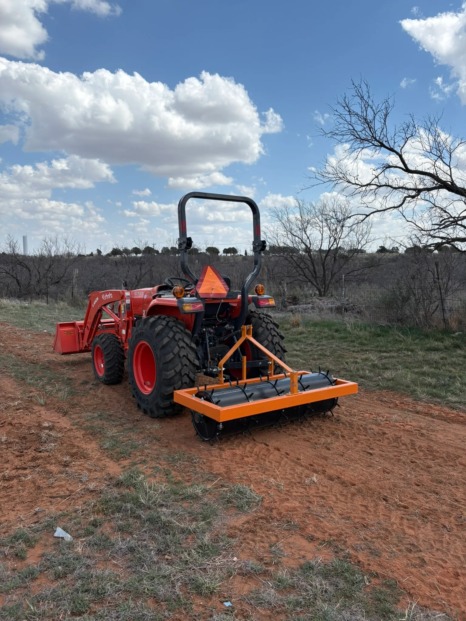 Tractor with 5-ft tractor 3-point cultipacker/aerator
