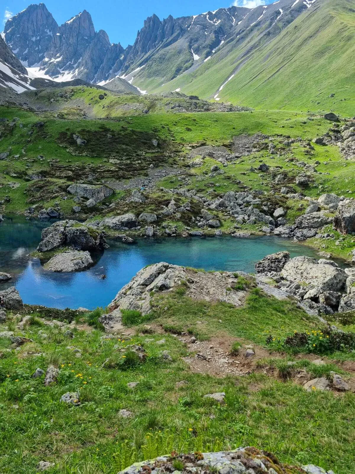 Blue Abudelauri Lake beneath the Chaukhi Mountains in Khevsureti, Georgia.