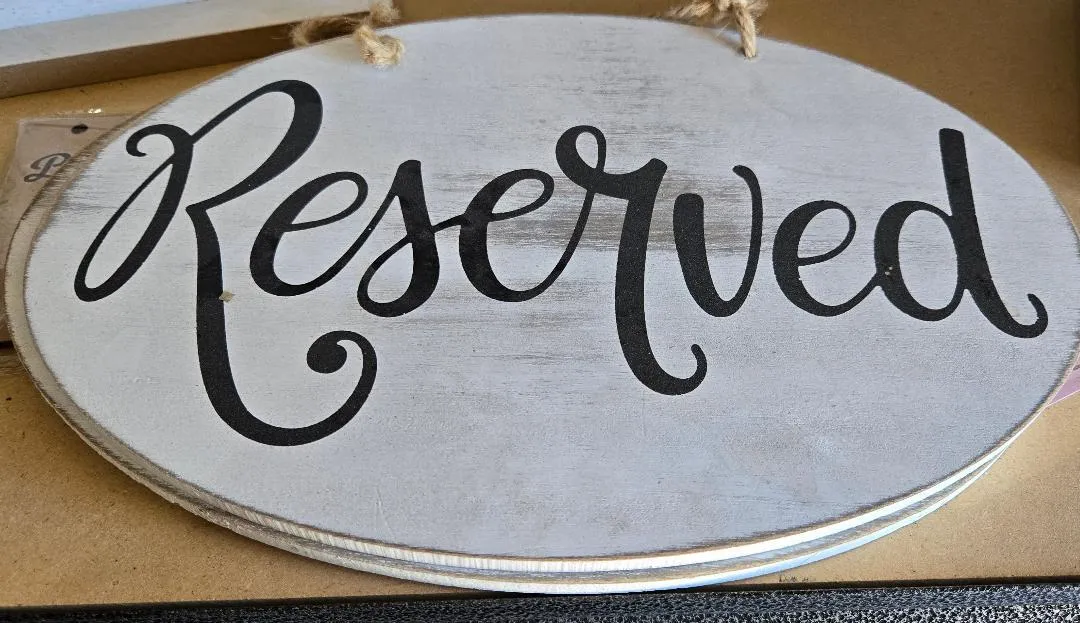 Hanging White Reserved Signs with Black Lettering