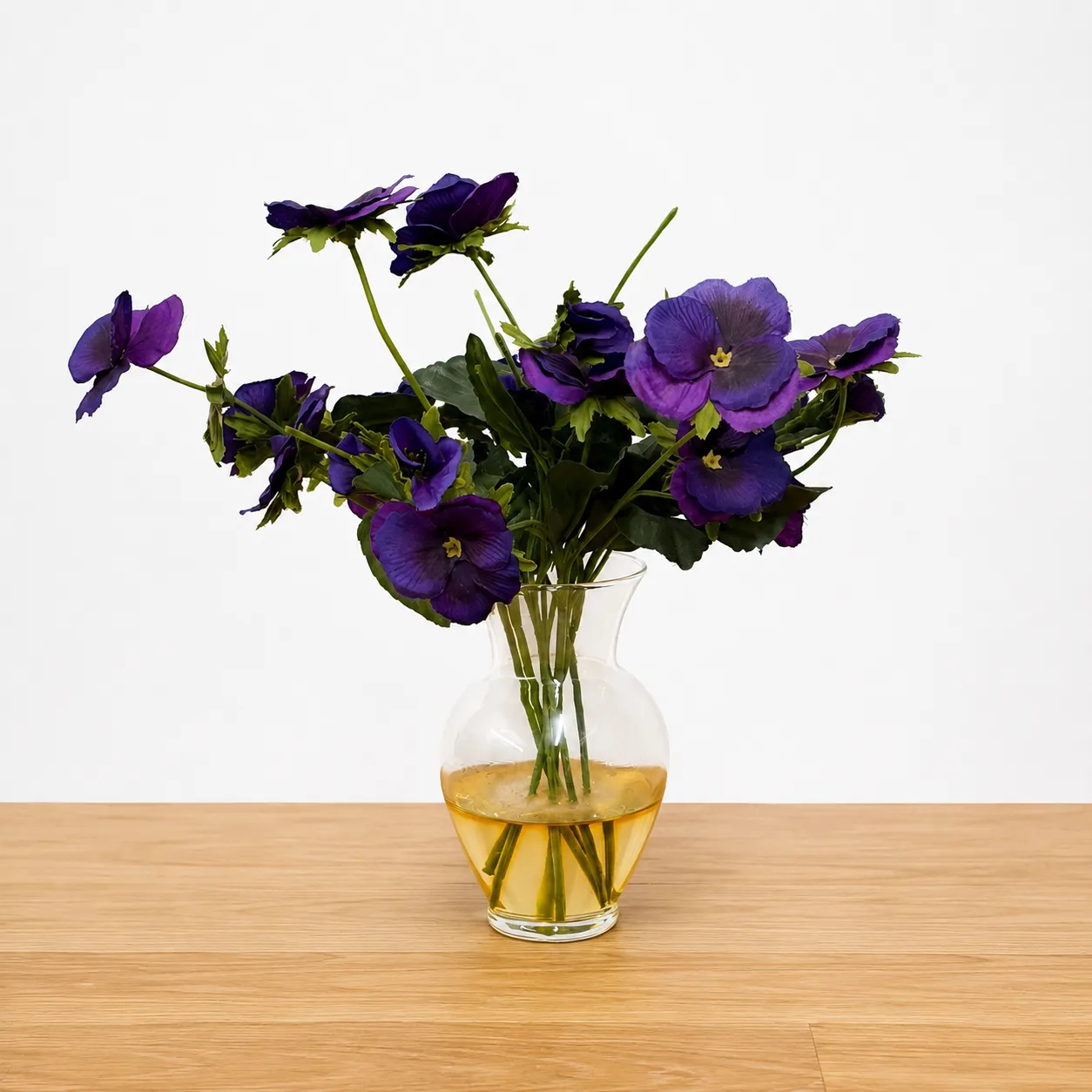 Artificial Purple Pansies in Glass Vase