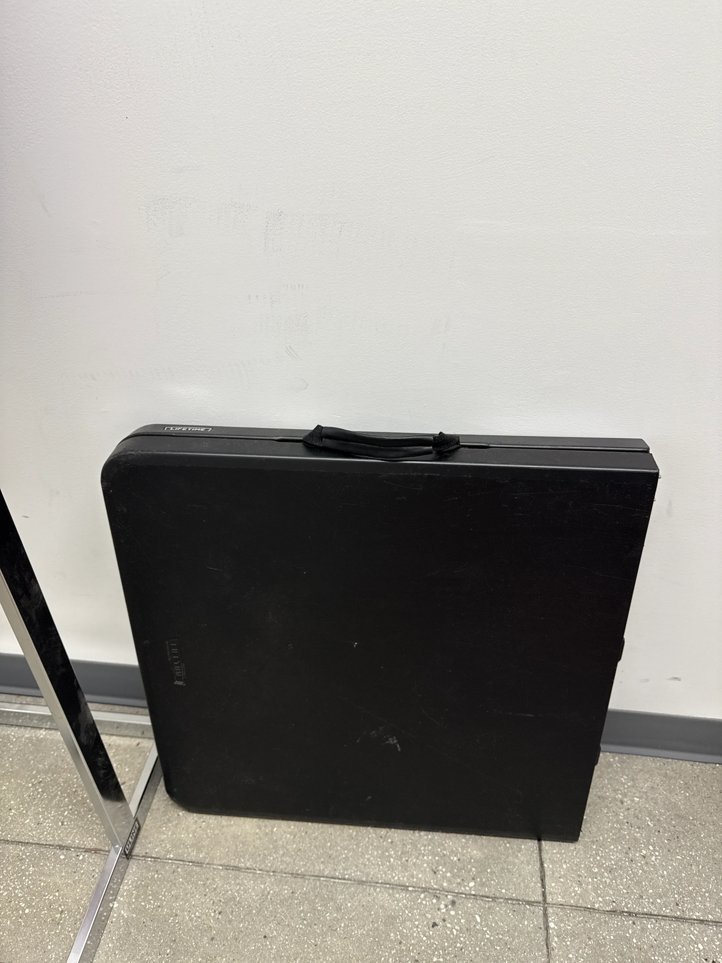 Black folding table (4' L x 2' W)