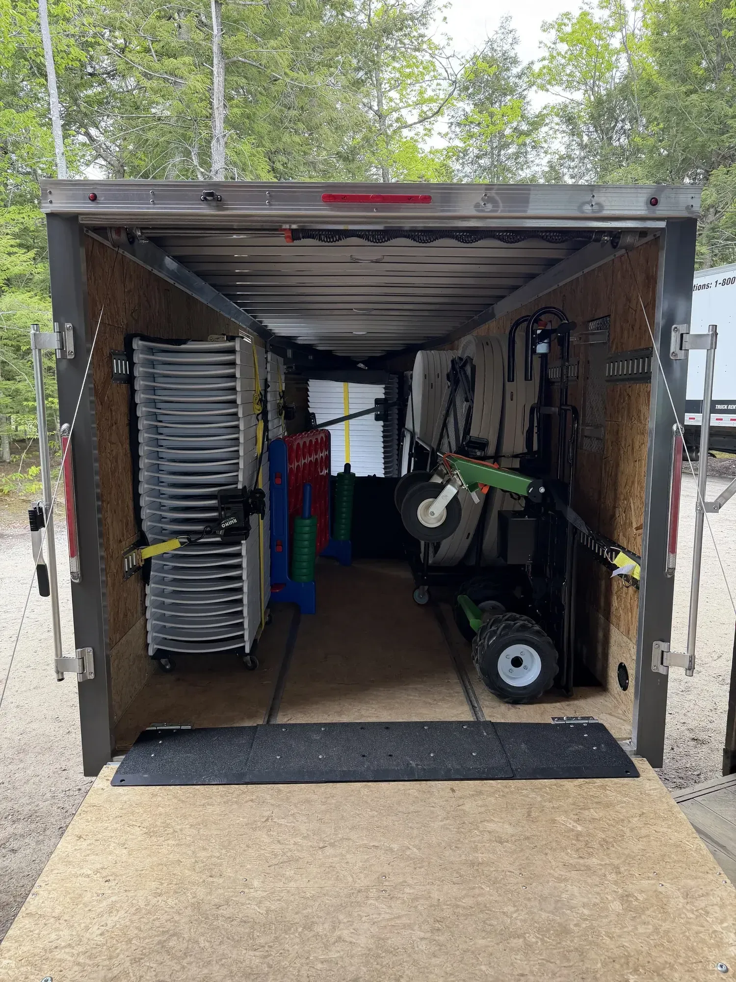 A Trailer loaded with chairs and tables for an event.