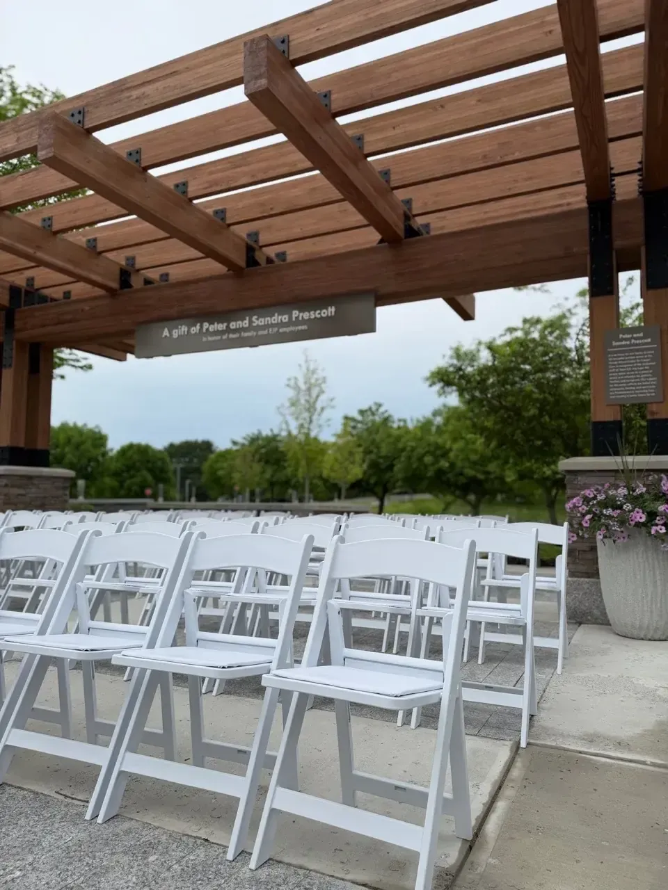 Resin chairs under a pergola in Augusta Maine