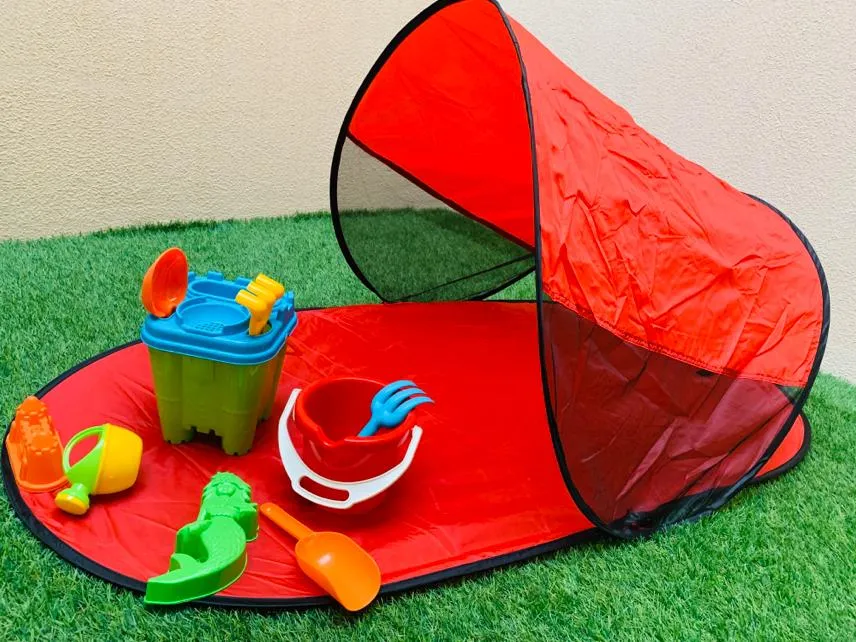 Beach shade with beach toys.