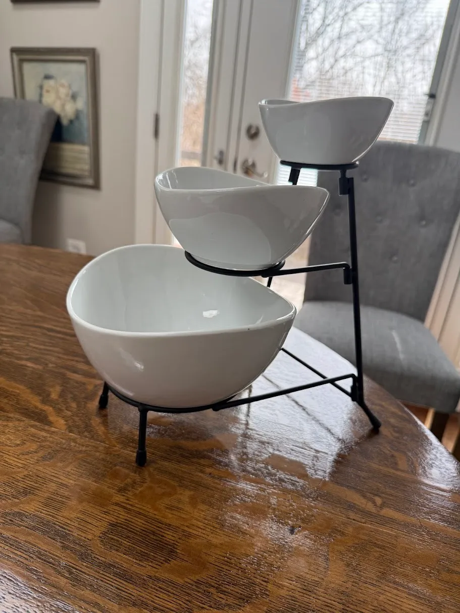 Black three tier stand with three white oval bowls. 12" tall.