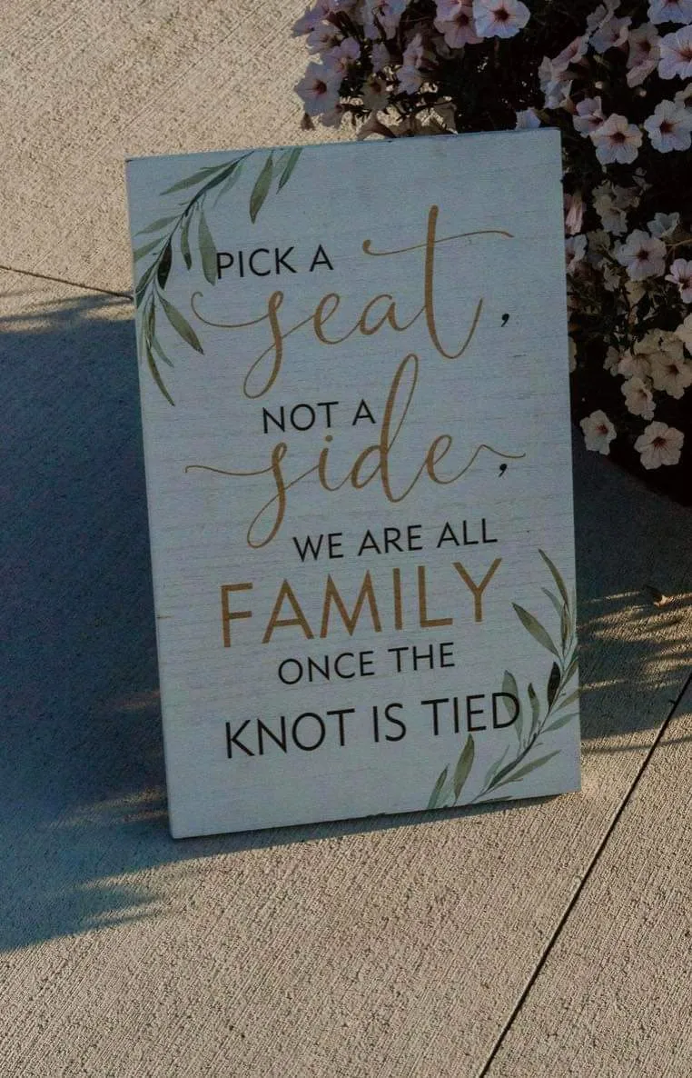 SIGN: "pick a seat, not a side, we all are family once the knot is tied" leaf design