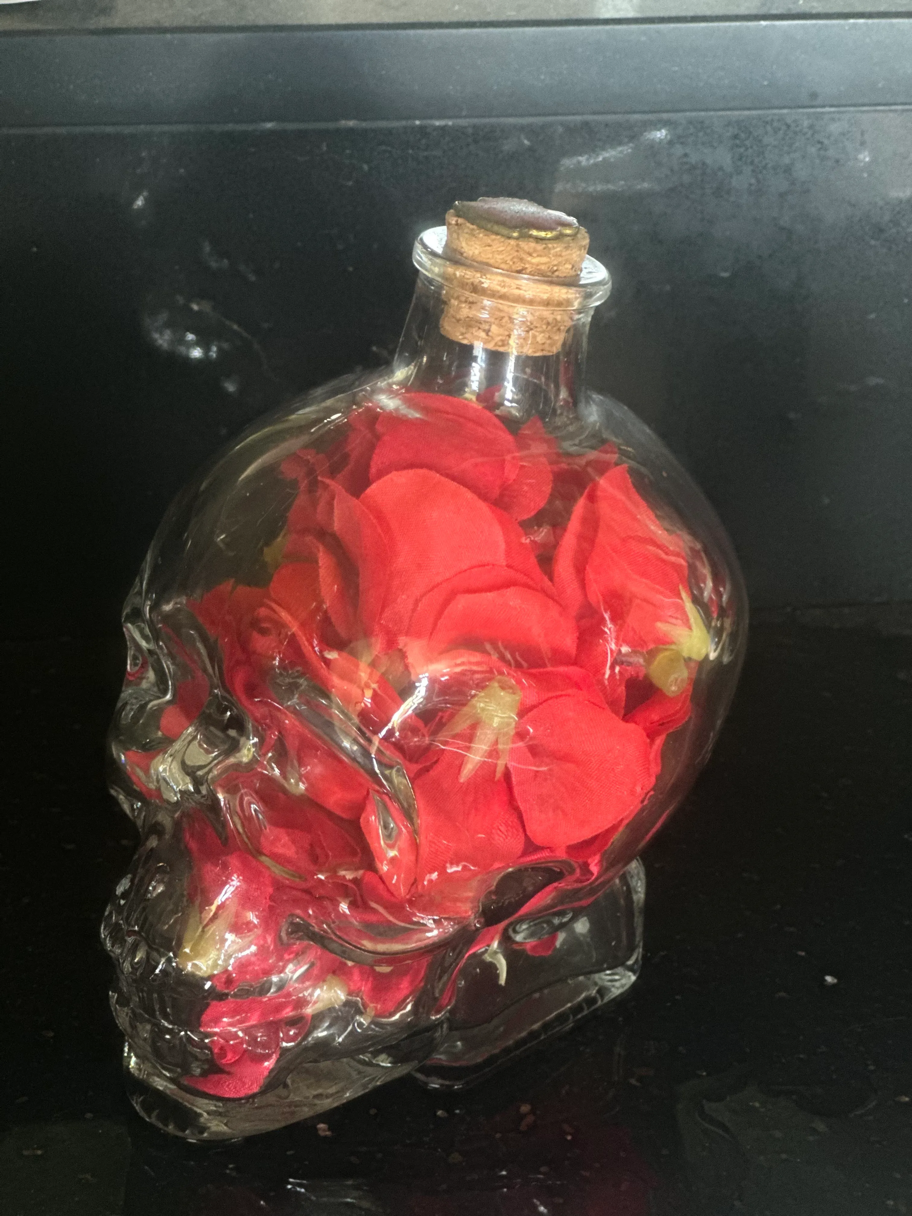 Small glass skull filled with poppies